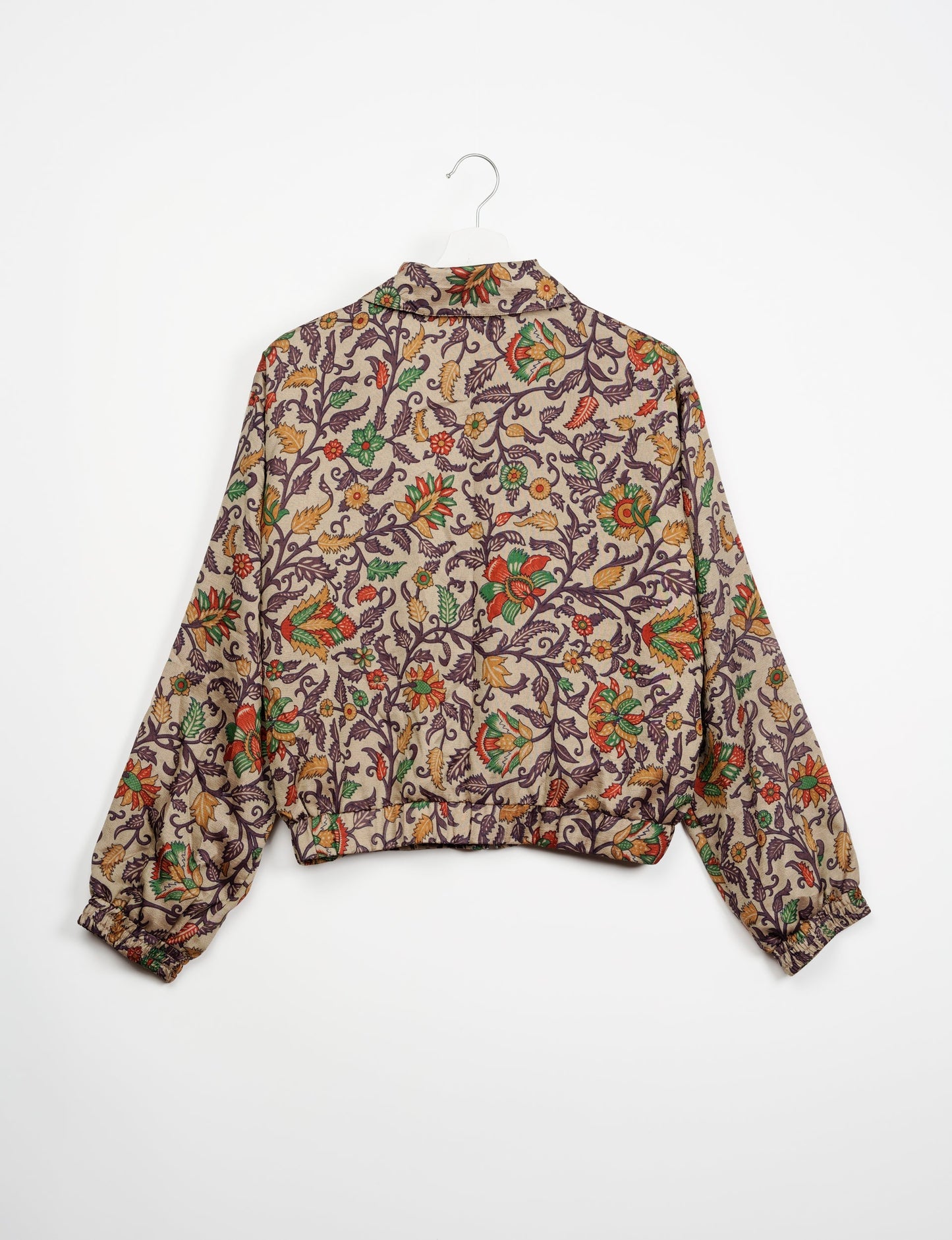 Stylish BOMBER JACKET, an upcycled clothing masterpiece with a cute cropped shape, elasticated details, and detachable metallic zipper. Contrast sari print lining adds a unique touch. Explore sustainable and eco-friendly fashion.