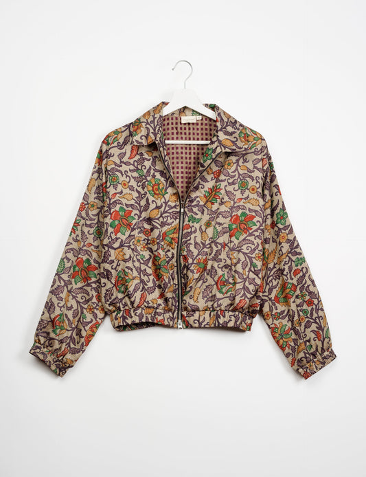 Stylish BOMBER JACKET, an upcycled clothing masterpiece with a cute cropped shape, elasticated details, and detachable metallic zipper. Contrast sari print lining adds a unique touch. Explore sustainable and eco-friendly fashion.