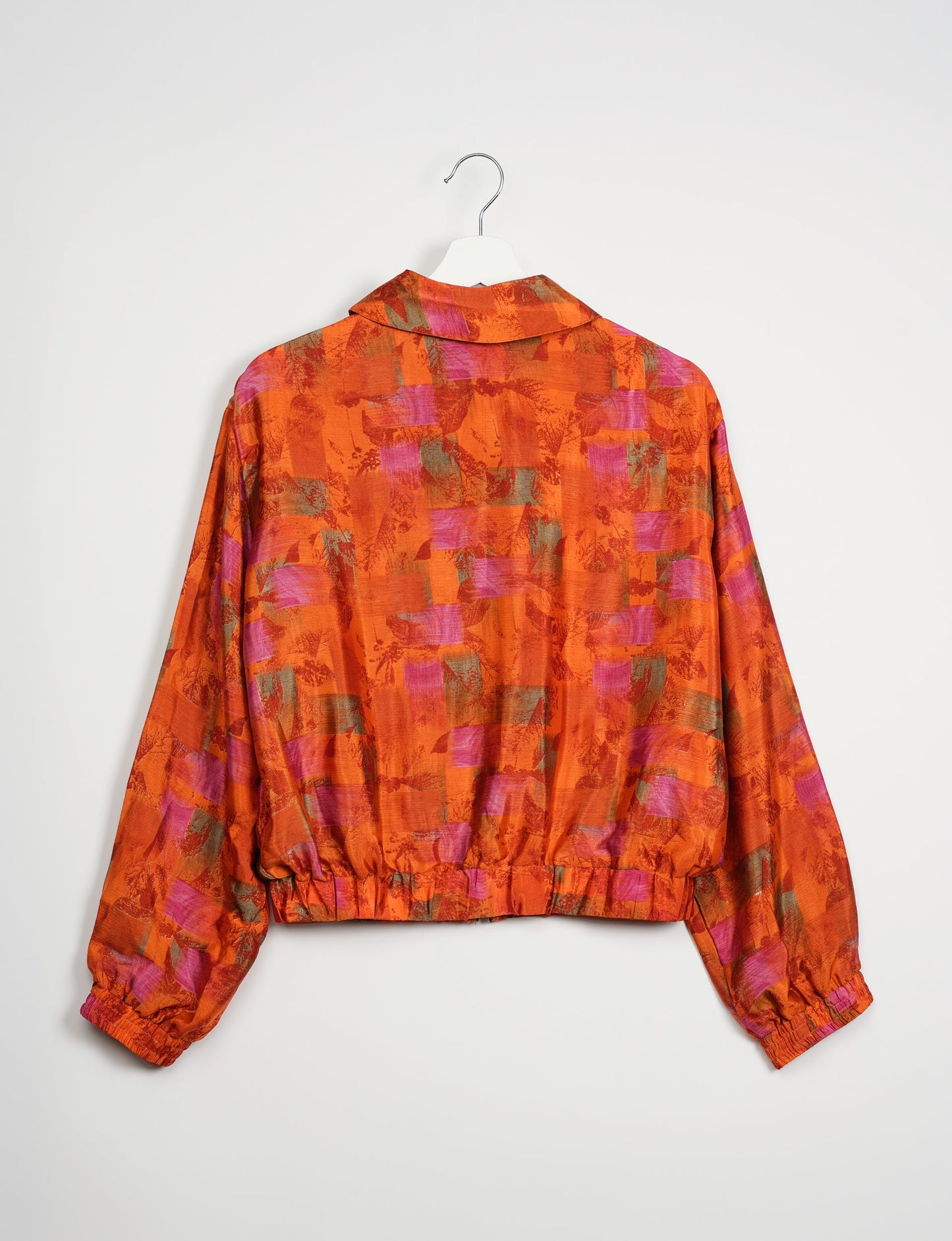 Stylish BOMBER JACKET, an upcycled clothing masterpiece with a cute cropped shape, elasticated details, and detachable metallic zipper. Contrast sari print lining adds a unique touch. Explore sustainable and eco-friendly fashion.