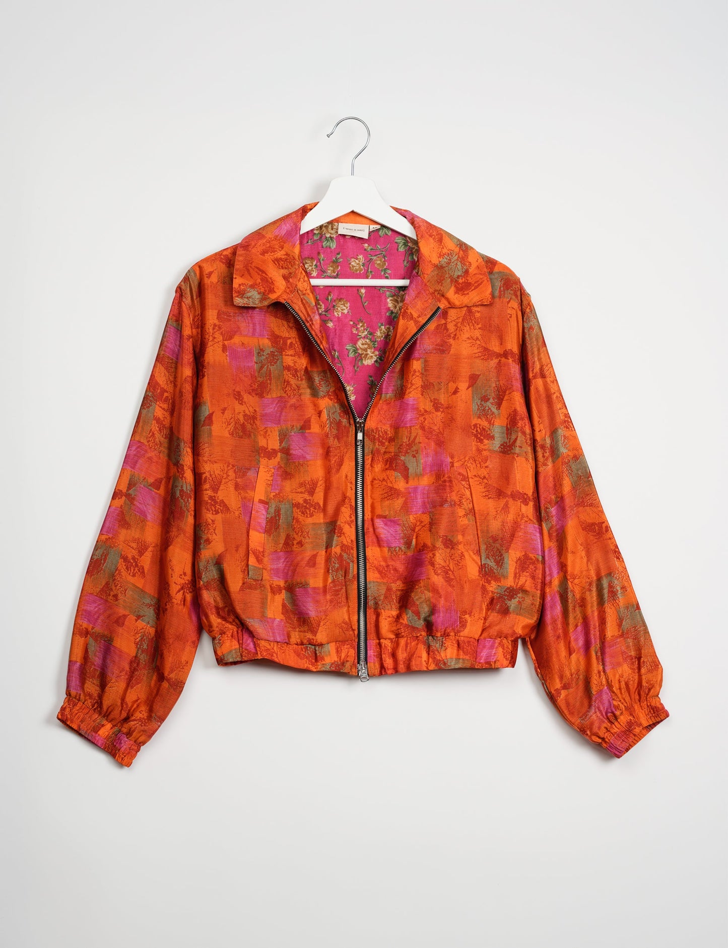 Stylish BOMBER JACKET, an upcycled clothing masterpiece with a cute cropped shape, elasticated details, and detachable metallic zipper. Contrast sari print lining adds a unique touch. Explore sustainable and eco-friendly fashion.