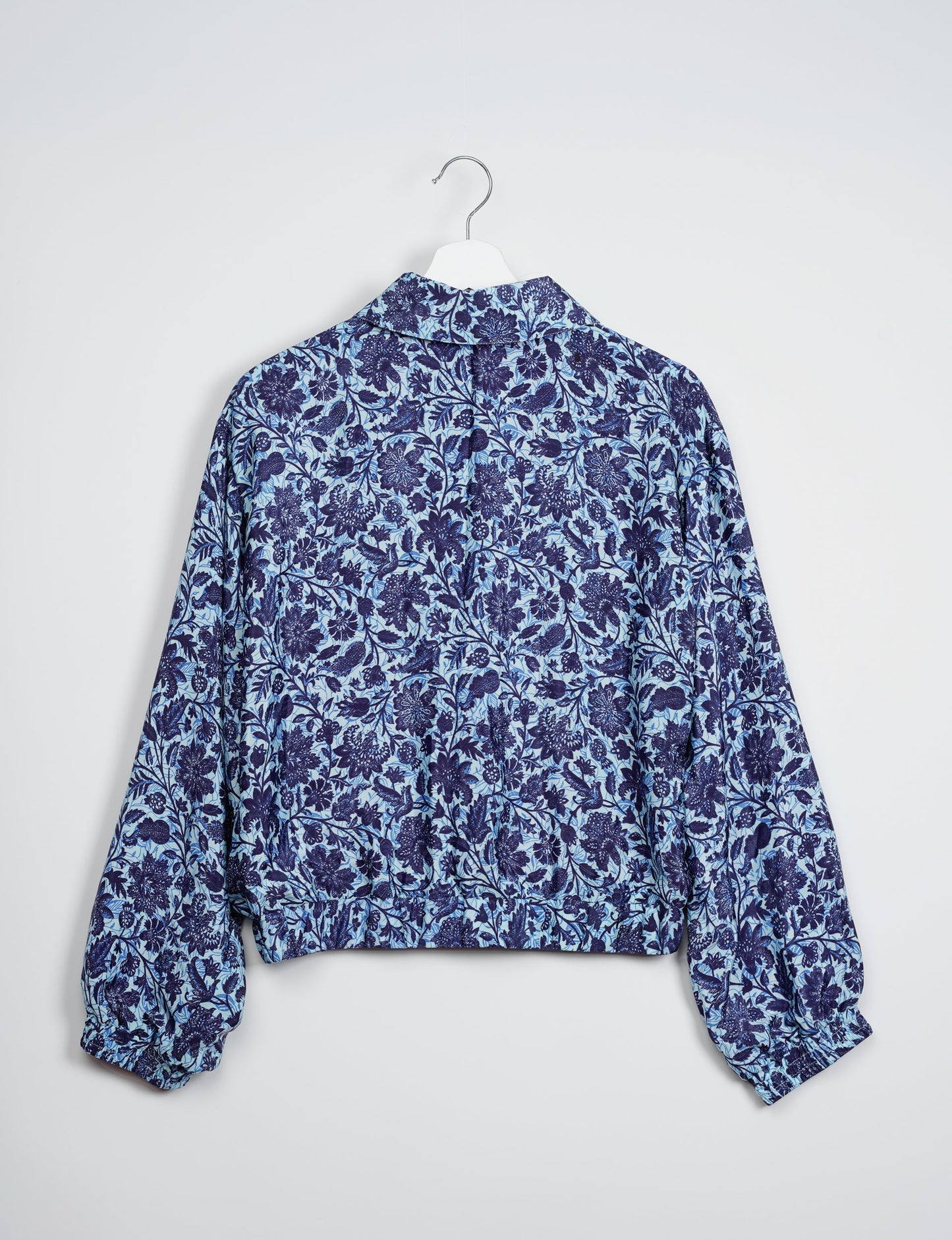 Stylish BOMBER JACKET, an upcycled clothing masterpiece with a cute cropped shape, elasticated details, and detachable metallic zipper. Contrast sari print lining adds a unique touch. Explore sustainable and eco-friendly fashion.