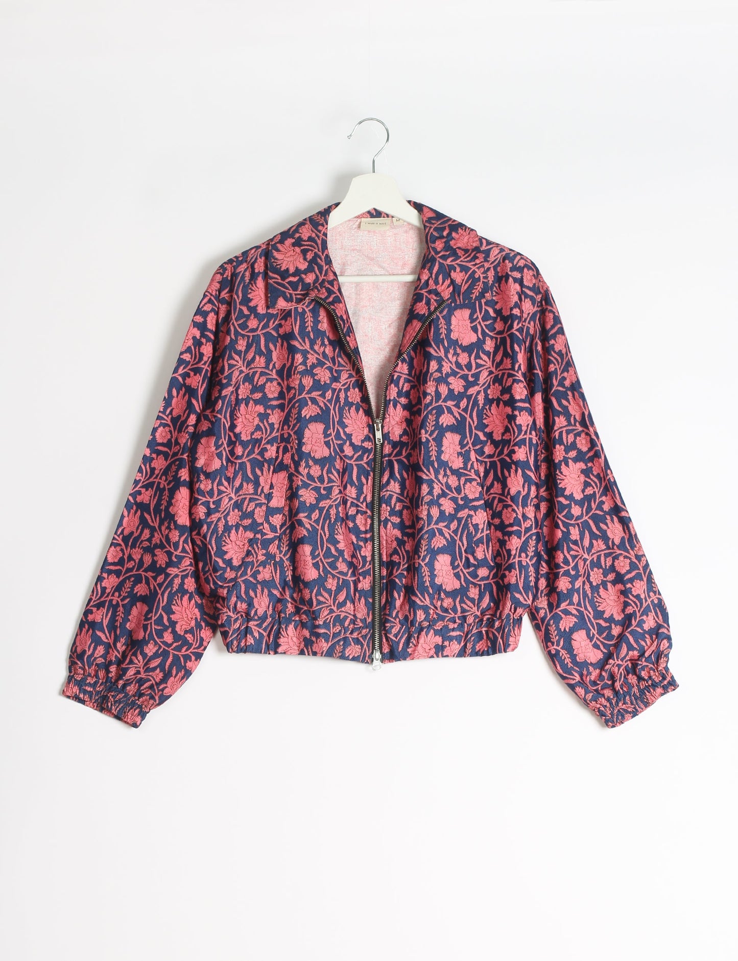 Stylish BOMBER JACKET, an upcycled clothing masterpiece with a cute cropped shape, elasticated details, and detachable metallic zipper. Contrast sari print lining adds a unique touch. Explore sustainable and eco-friendly fashion.