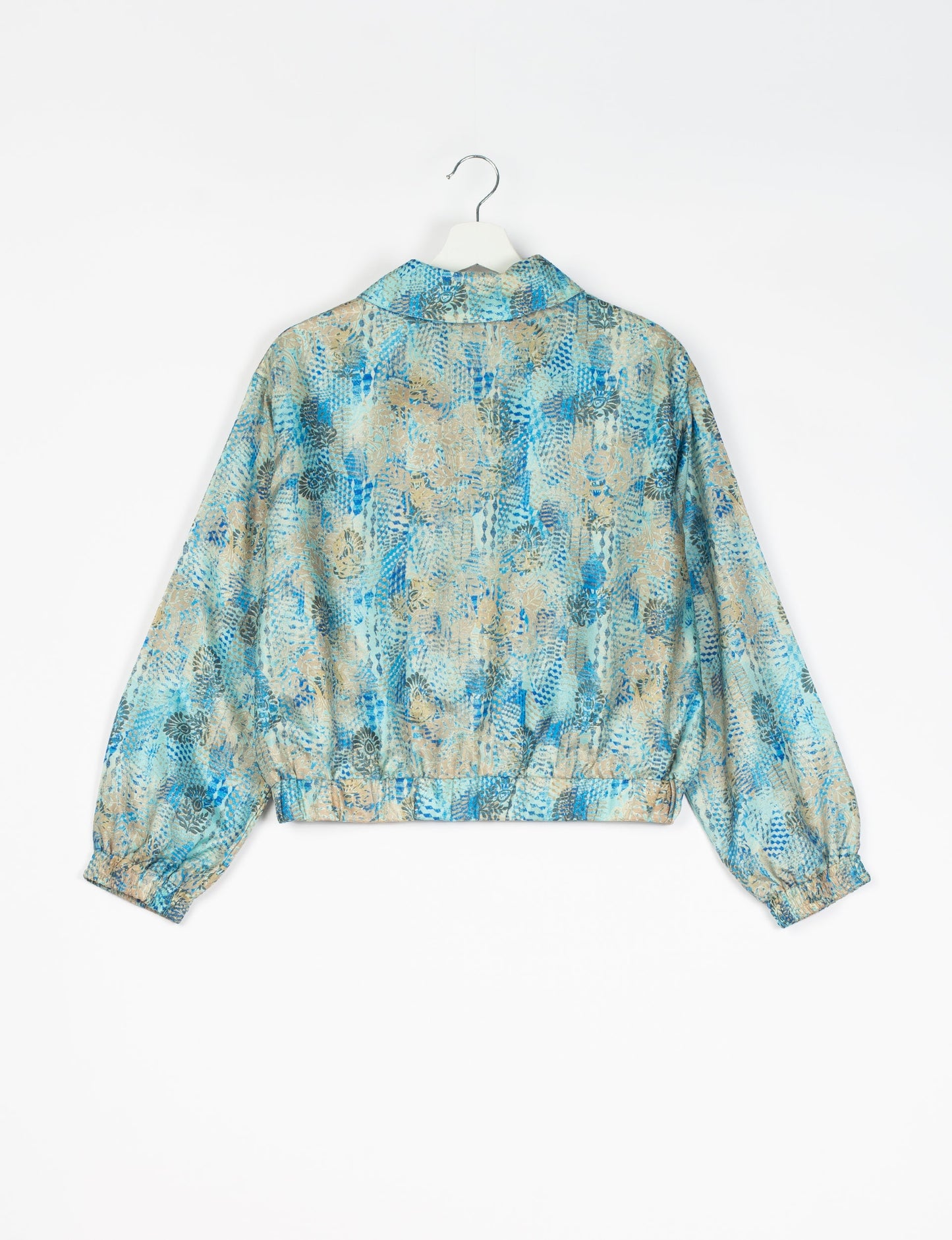 Stylish BOMBER JACKET, an upcycled clothing masterpiece with a cute cropped shape, elasticated details, and detachable metallic zipper. Contrast sari print lining adds a unique touch. Explore sustainable and eco-friendly fashion.