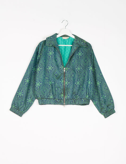 Stylish BOMBER JACKET, an upcycled clothing masterpiece with a cute cropped shape, elasticated details, and detachable metallic zipper. Contrast sari print lining adds a unique touch. Explore sustainable and eco-friendly fashion.