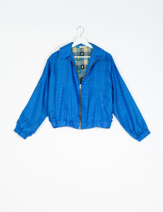 Stylish BOMBER JACKET, an upcycled clothing masterpiece with a cute cropped shape, elasticated details, and detachable metallic zipper. Contrast sari print lining adds a unique touch. Explore sustainable and eco-friendly fashion.