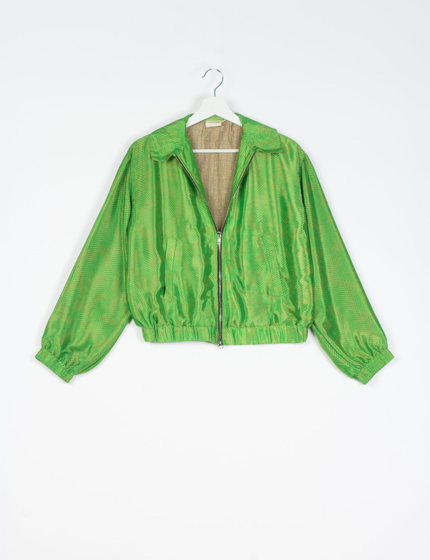 Stylish BOMBER JACKET, an upcycled clothing masterpiece with a cute cropped shape, elasticated details, and detachable metallic zipper. Contrast sari print lining adds a unique touch. Explore sustainable and eco-friendly fashion.