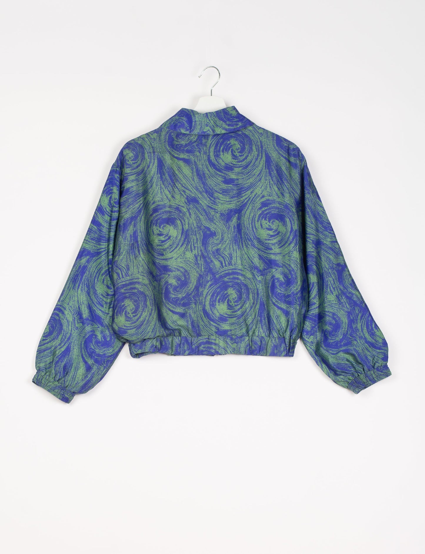 Stylish BOMBER JACKET, an upcycled clothing masterpiece with a cute cropped shape, elasticated details, and detachable metallic zipper. Contrast sari print lining adds a unique touch. Explore sustainable and eco-friendly fashion.