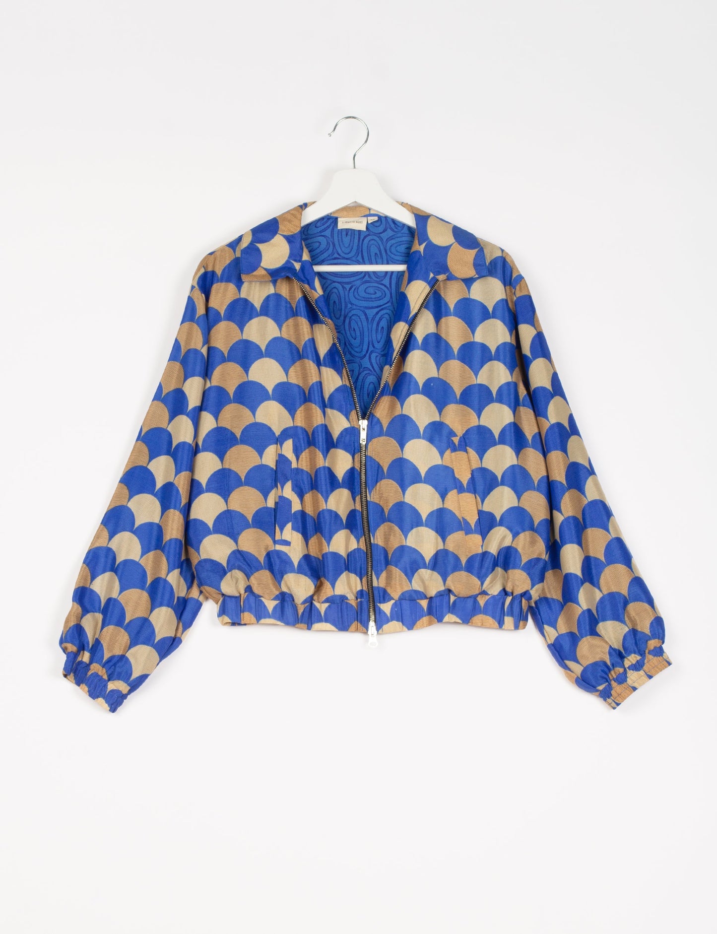 Stylish BOMBER JACKET, an upcycled clothing masterpiece with a cute cropped shape, elasticated details, and detachable metallic zipper. Contrast sari print lining adds a unique touch. Explore sustainable and eco-friendly fashion.