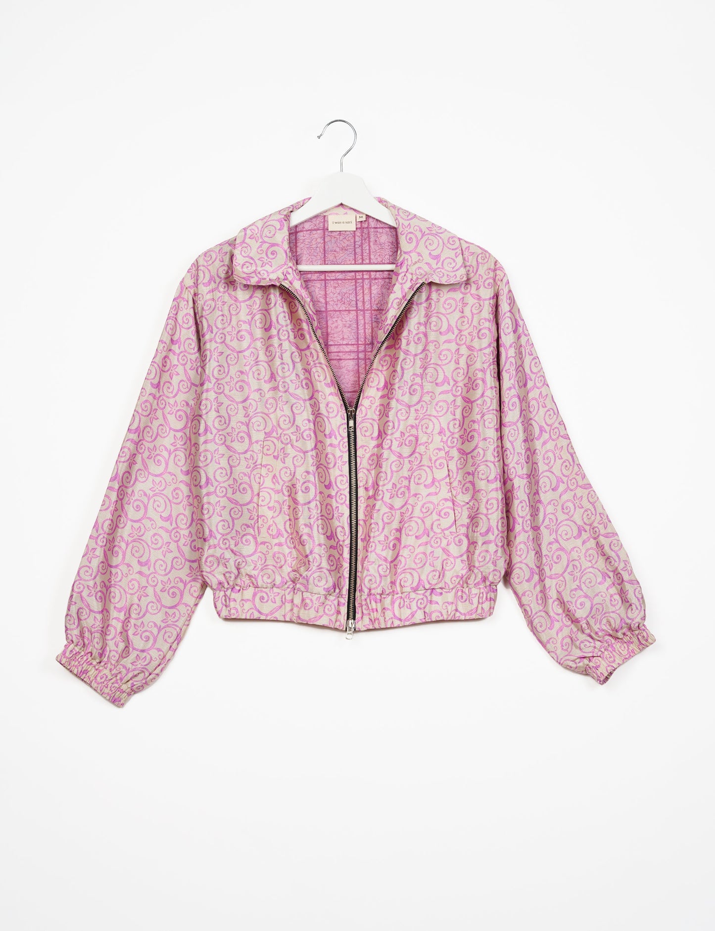 Stylish BOMBER JACKET, an upcycled clothing masterpiece with a cute cropped shape, elasticated details, and detachable metallic zipper. Contrast sari print lining adds a unique touch. Explore sustainable and eco-friendly fashion.