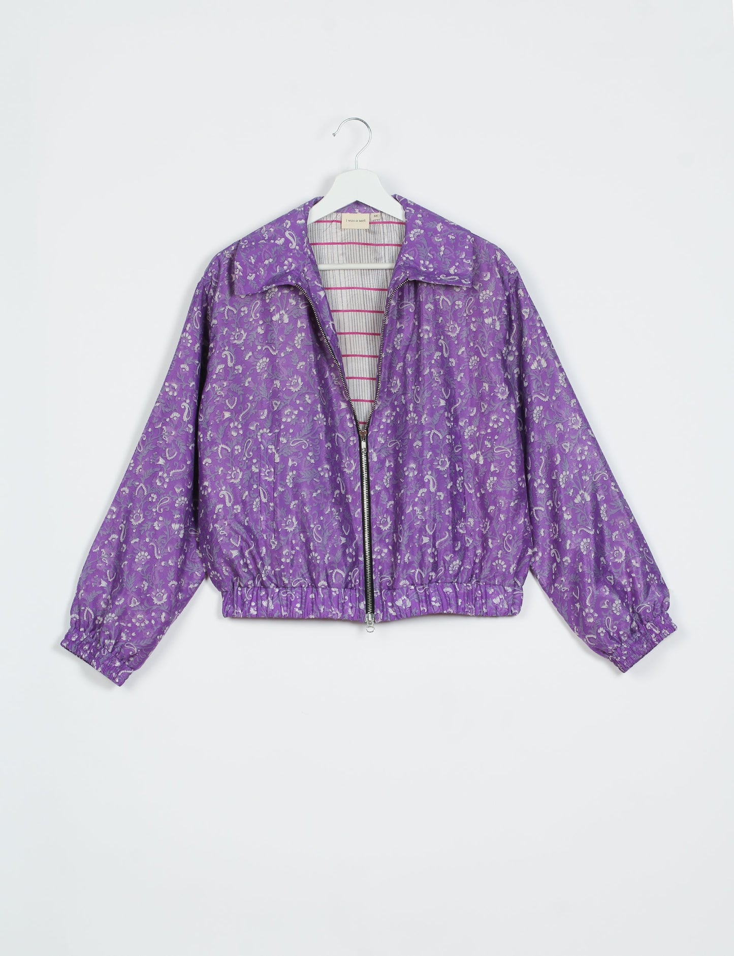 Stylish BOMBER JACKET, an upcycled clothing masterpiece with a cute cropped shape, elasticated details, and detachable metallic zipper. Contrast sari print lining adds a unique touch. Explore sustainable and eco-friendly fashion.