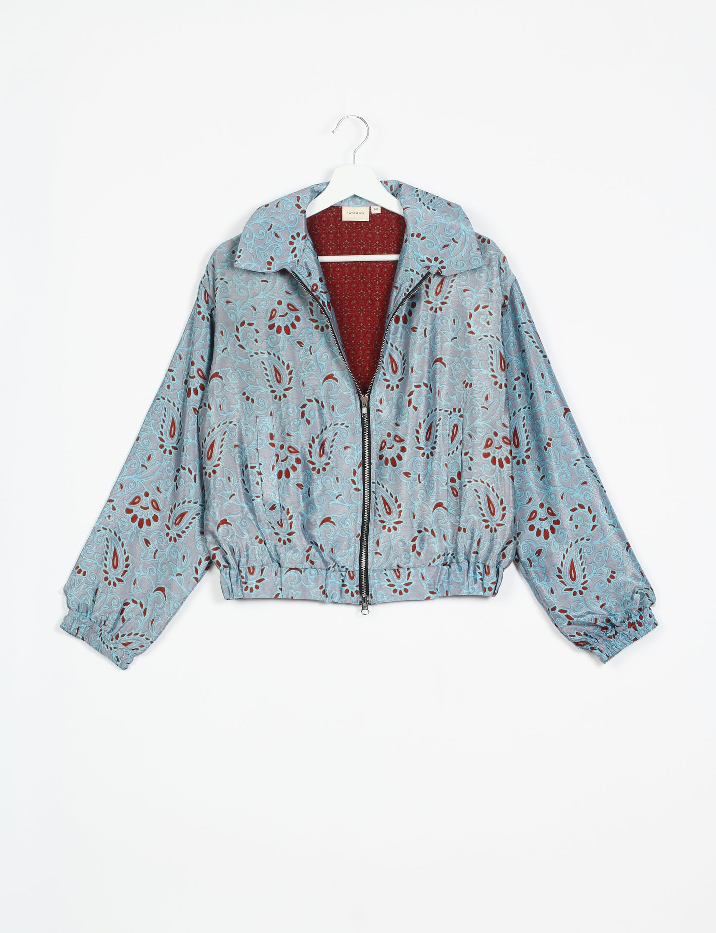 Stylish BOMBER JACKET, an upcycled clothing masterpiece with a cute cropped shape, elasticated details, and detachable metallic zipper. Contrast sari print lining adds a unique touch. Explore sustainable and eco-friendly fashion.