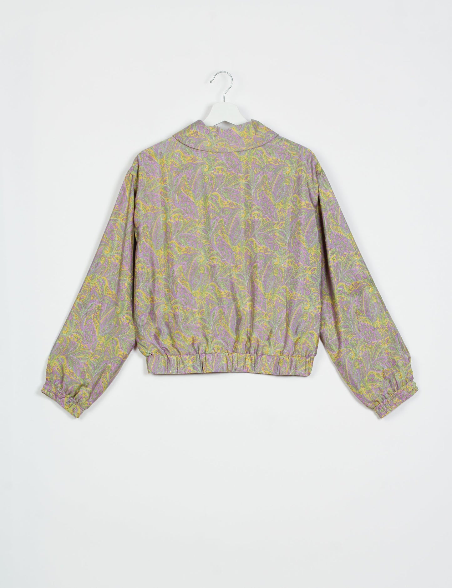 Stylish BOMBER JACKET, an upcycled clothing masterpiece with a cute cropped shape, elasticated details, and detachable metallic zipper. Contrast sari print lining adds a unique touch. Explore sustainable and eco-friendly fashion.