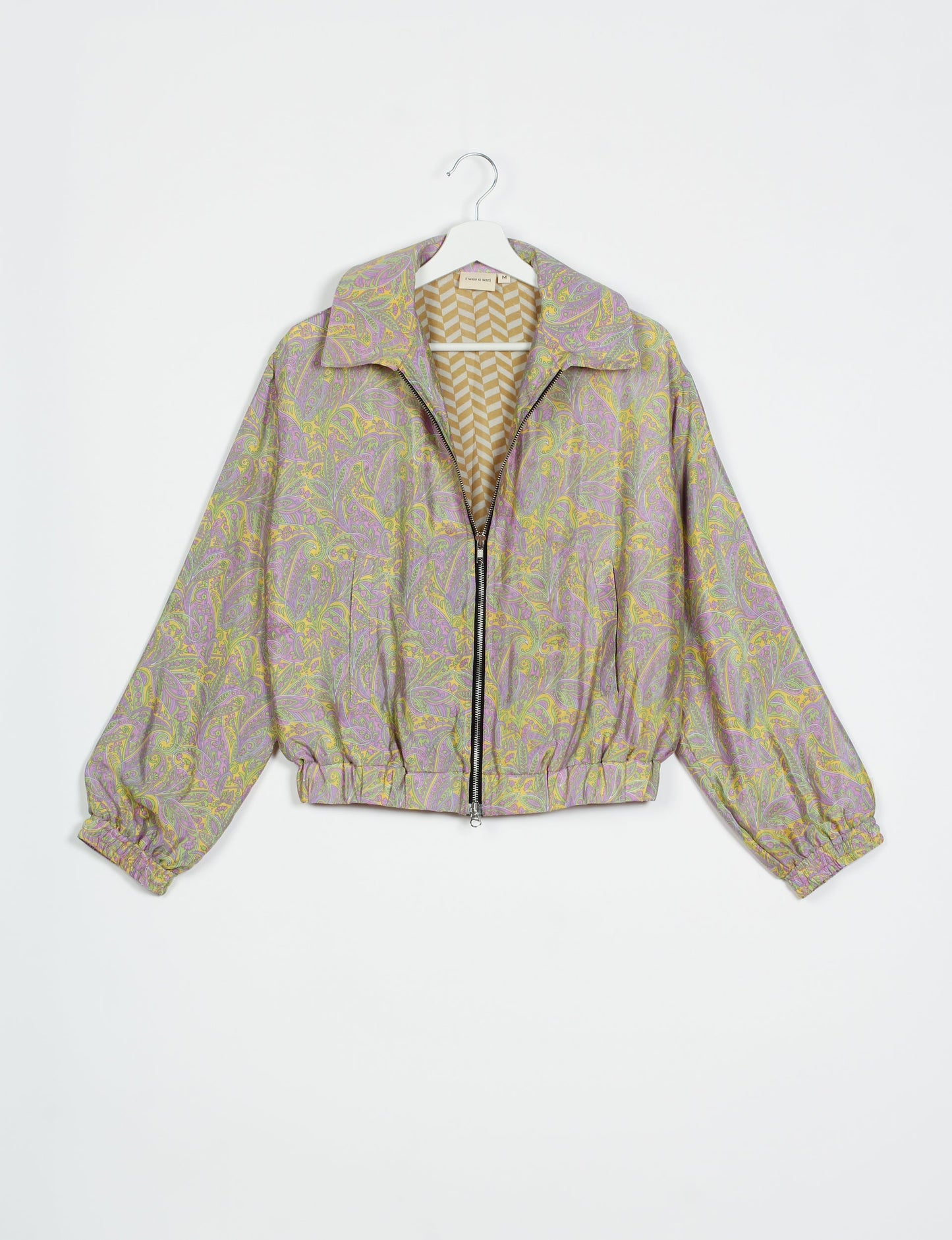 Stylish BOMBER JACKET, an upcycled clothing masterpiece with a cute cropped shape, elasticated details, and detachable metallic zipper. Contrast sari print lining adds a unique touch. Explore sustainable and eco-friendly fashion.