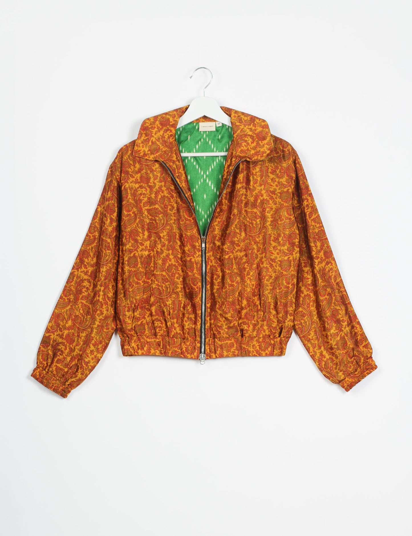 Stylish BOMBER JACKET, an upcycled clothing masterpiece with a cute cropped shape, elasticated details, and detachable metallic zipper. Contrast sari print lining adds a unique touch. Explore sustainable and eco-friendly fashion.