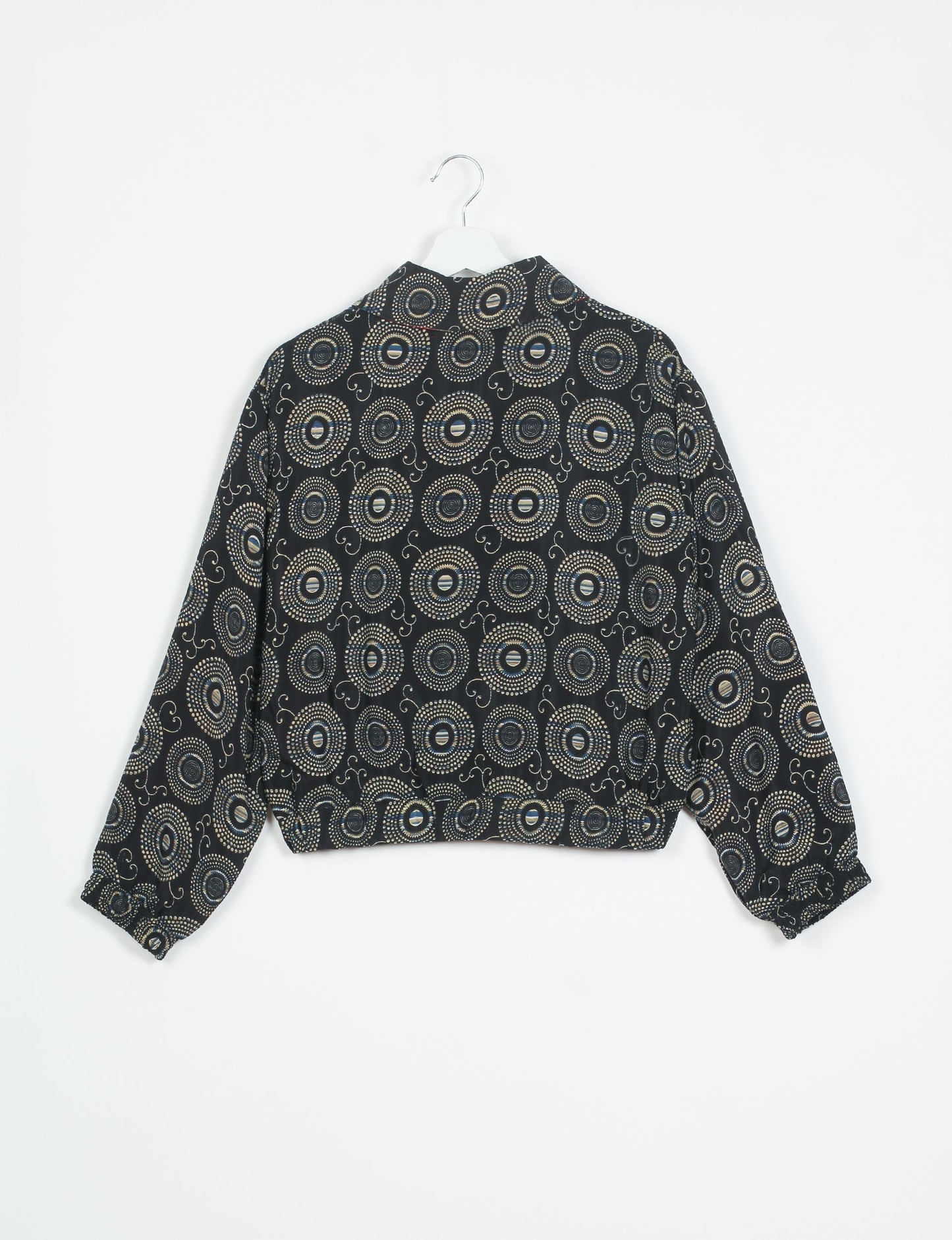 Stylish BOMBER JACKET, an upcycled clothing masterpiece with a cute cropped shape, elasticated details, and detachable metallic zipper. Contrast sari print lining adds a unique touch. Explore sustainable and eco-friendly fashion.