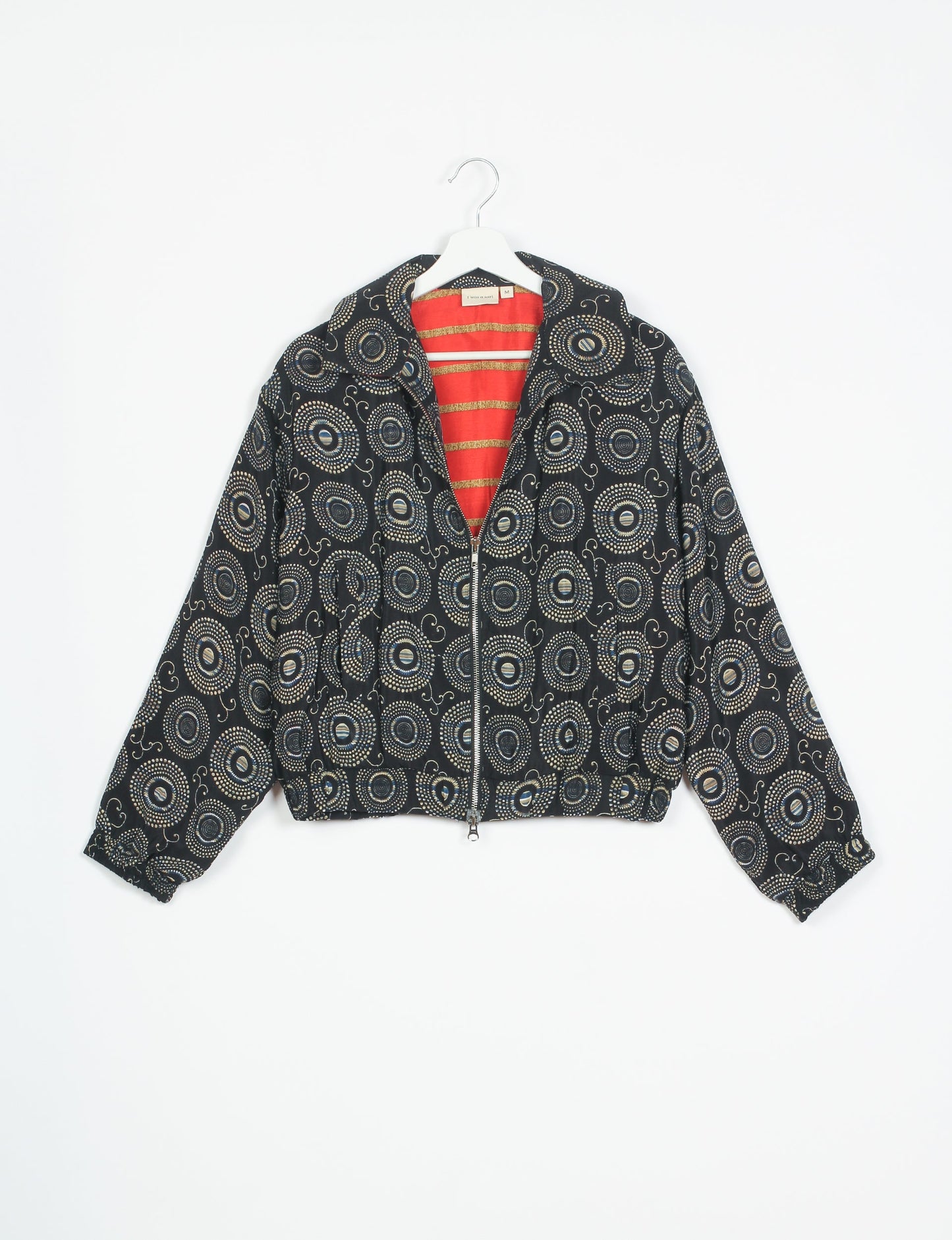 Stylish BOMBER JACKET, an upcycled clothing masterpiece with a cute cropped shape, elasticated details, and detachable metallic zipper. Contrast sari print lining adds a unique touch. Explore sustainable and eco-friendly fashion.