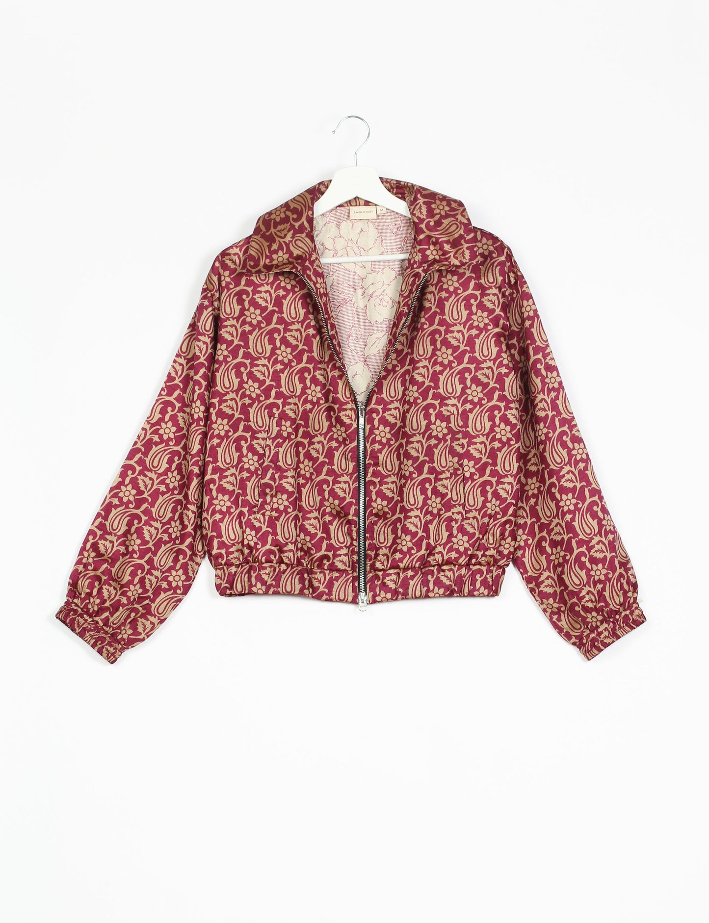 Stylish BOMBER JACKET, an upcycled clothing masterpiece with a cute cropped shape, elasticated details, and detachable metallic zipper. Contrast sari print lining adds a unique touch. Explore sustainable and eco-friendly fashion.