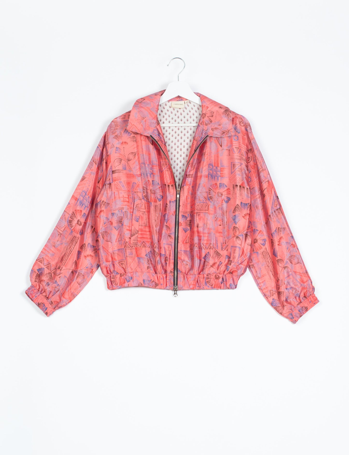 Stylish BOMBER JACKET, an upcycled clothing masterpiece with a cute cropped shape, elasticated details, and detachable metallic zipper. Contrast sari print lining adds a unique touch. Explore sustainable and eco-friendly fashion.