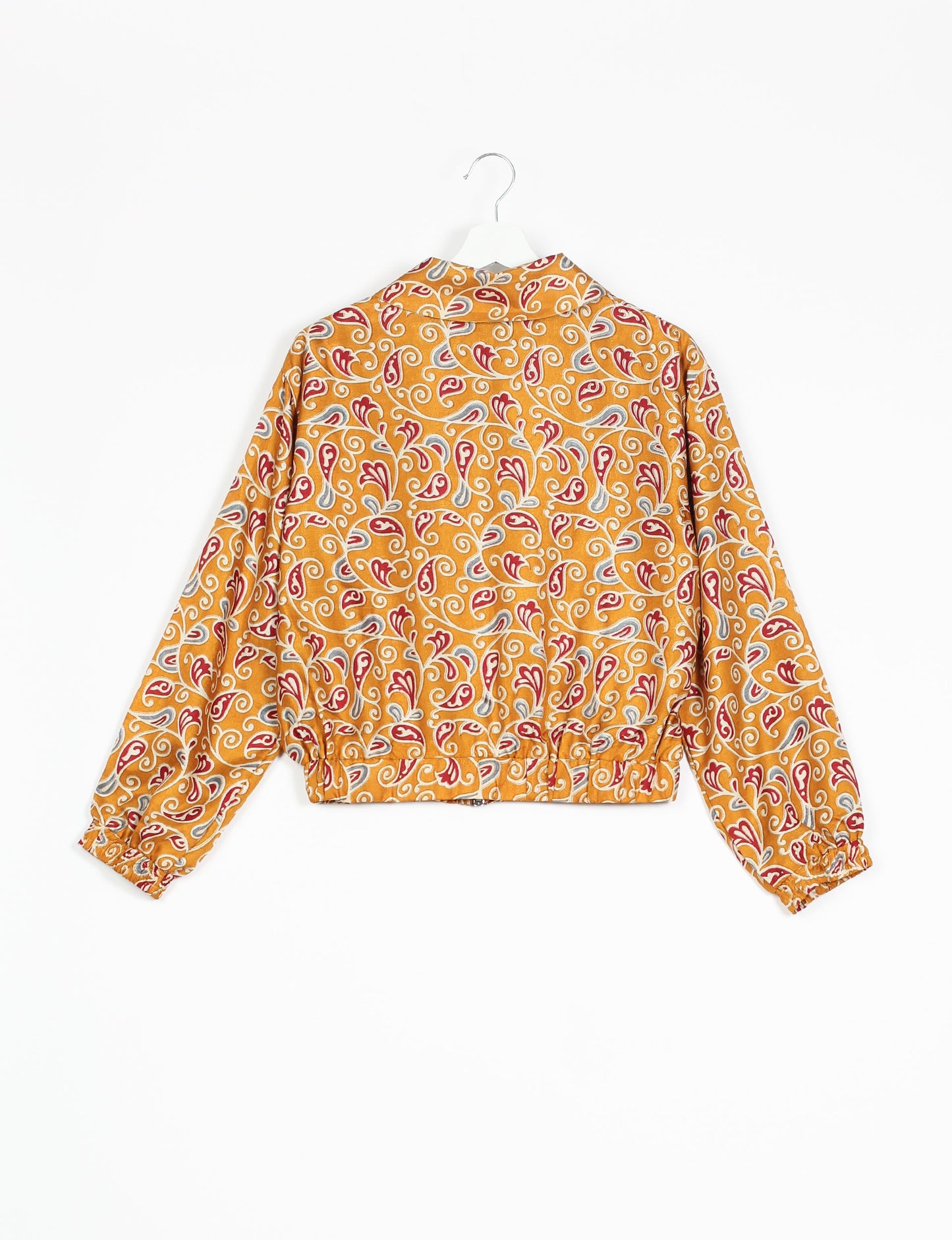 Stylish BOMBER JACKET, an upcycled clothing masterpiece with a cute cropped shape, elasticated details, and detachable metallic zipper. Contrast sari print lining adds a unique touch. Explore sustainable and eco-friendly fashion.