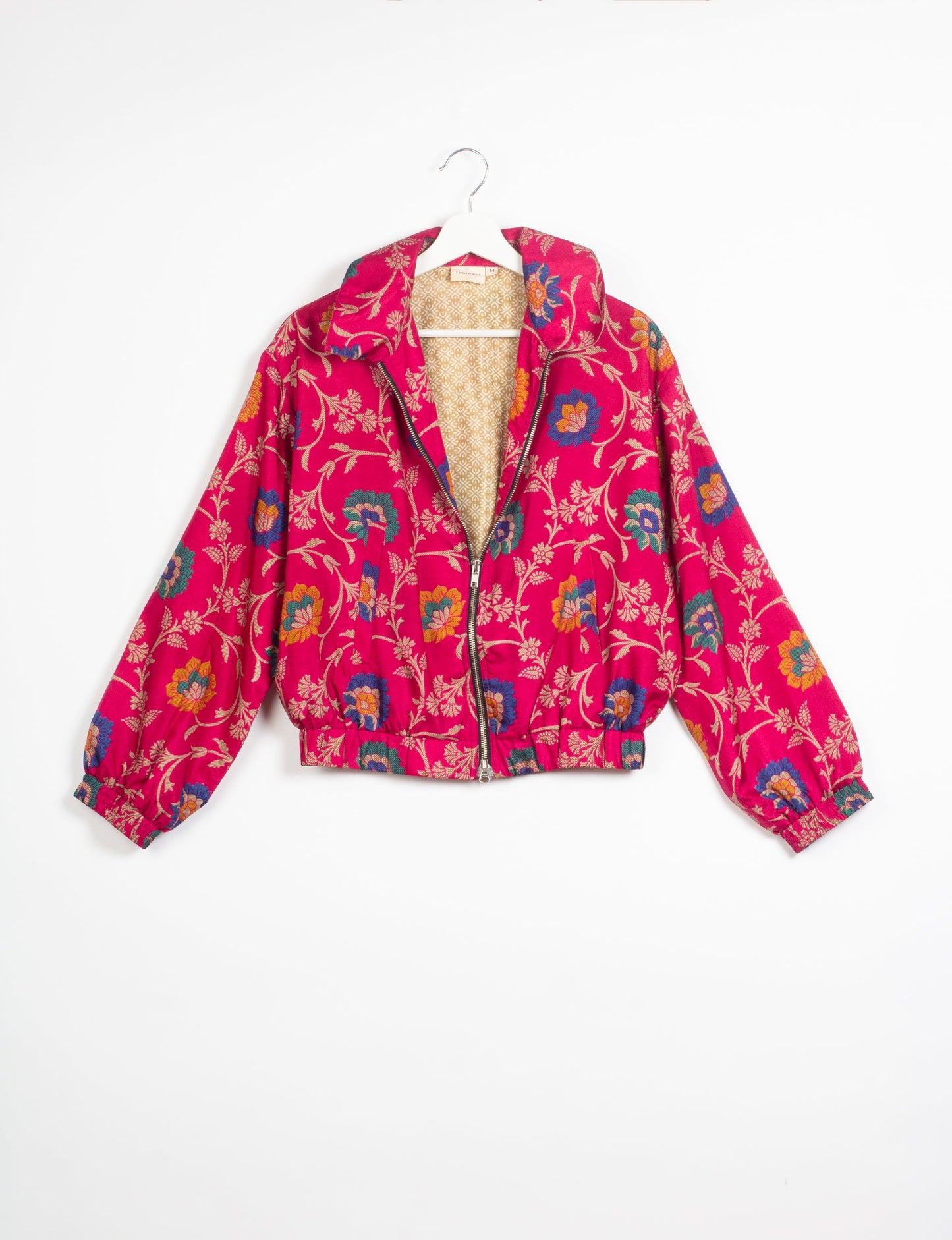 Stylish BOMBER JACKET, an upcycled clothing masterpiece with a cute cropped shape, elasticated details, and detachable metallic zipper. Contrast sari print lining adds a unique touch. Explore sustainable and eco-friendly fashion.