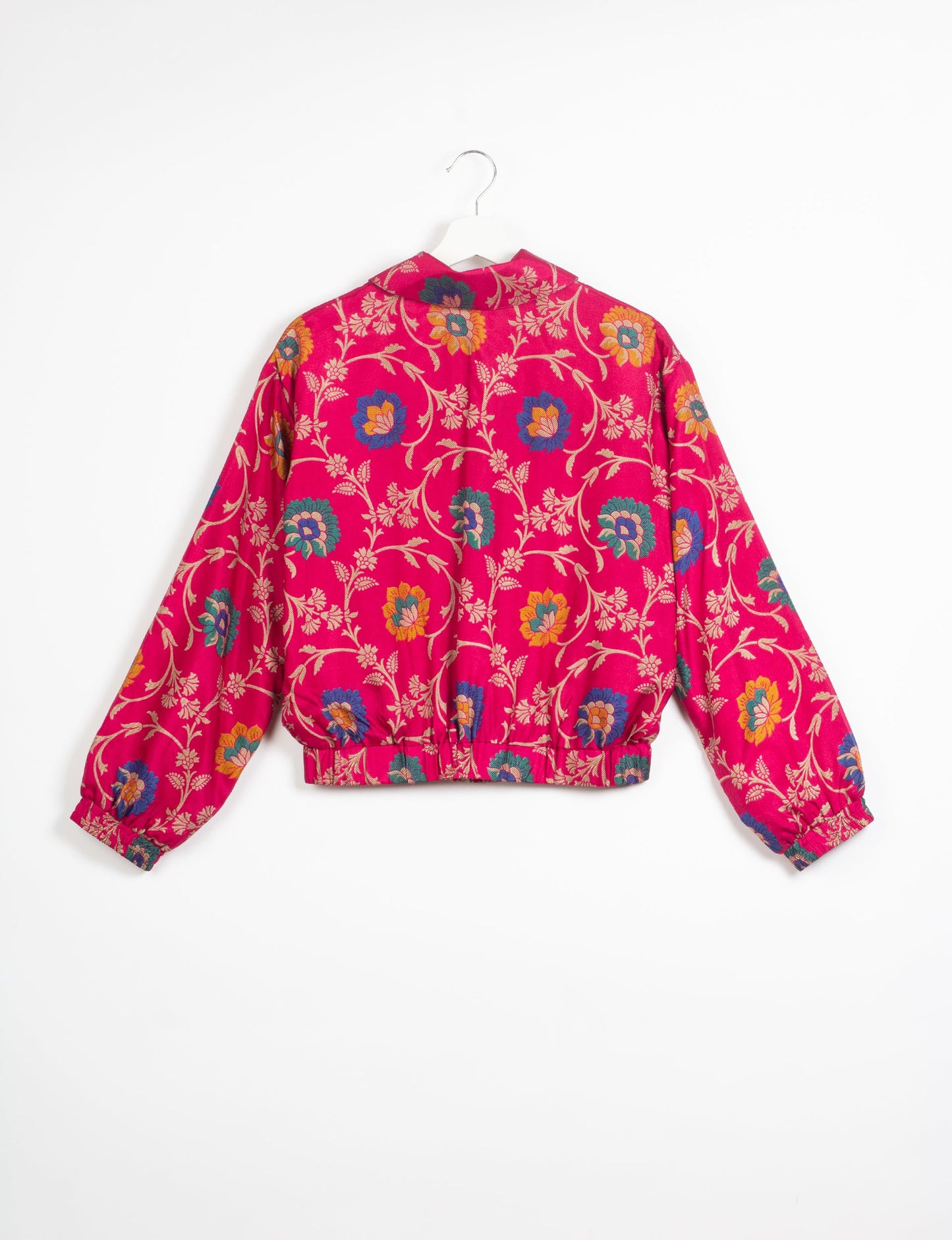 Stylish BOMBER JACKET, an upcycled clothing masterpiece with a cute cropped shape, elasticated details, and detachable metallic zipper. Contrast sari print lining adds a unique touch. Explore sustainable and eco-friendly fashion.