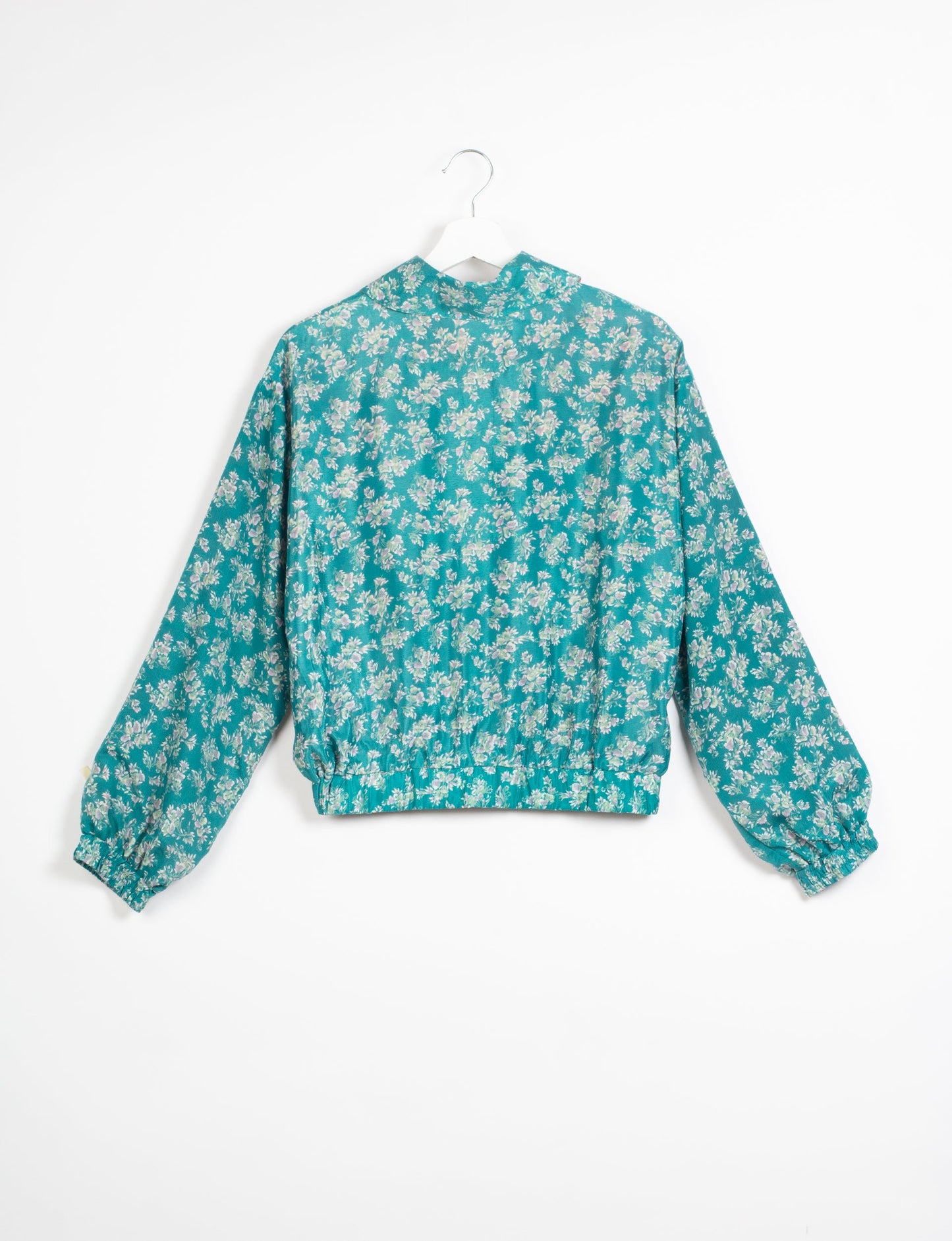 Stylish BOMBER JACKET, an upcycled clothing masterpiece with a cute cropped shape, elasticated details, and detachable metallic zipper. Contrast sari print lining adds a unique touch. Explore sustainable and eco-friendly fashion.