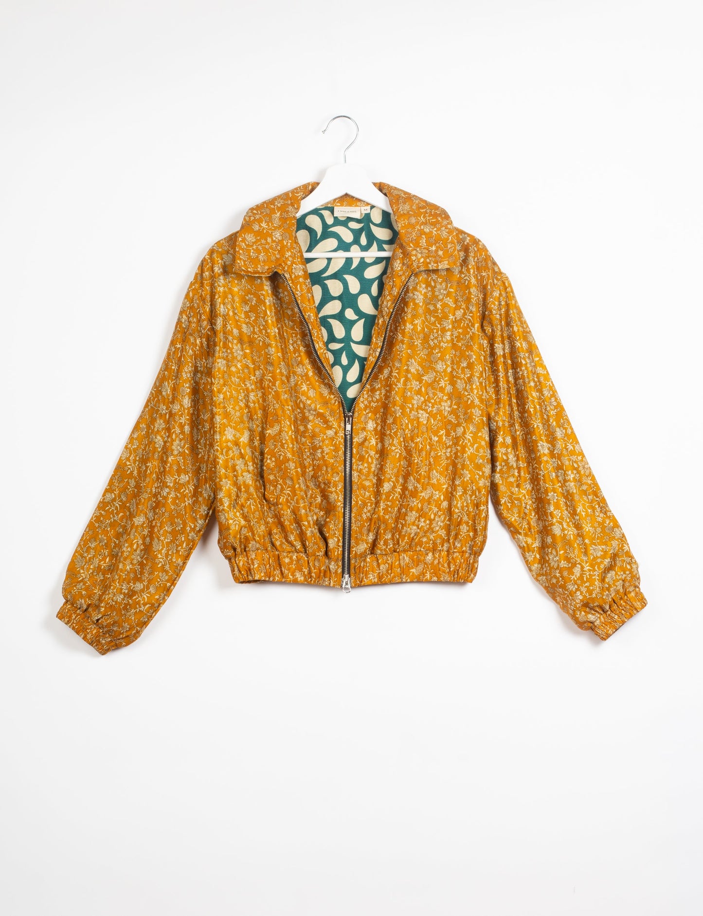 Stylish BOMBER JACKET, an upcycled clothing masterpiece with a cute cropped shape, elasticated details, and detachable metallic zipper. Contrast sari print lining adds a unique touch. Explore sustainable and eco-friendly fashion.