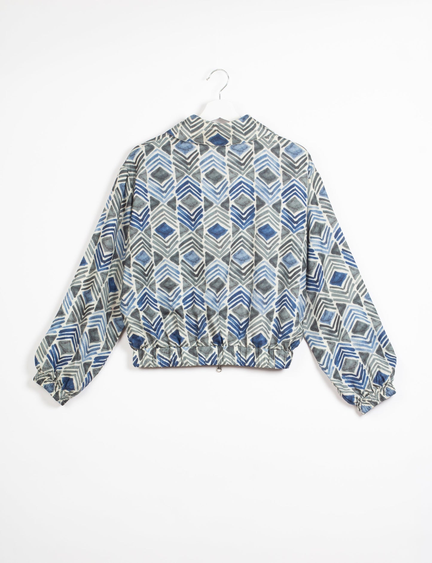 Stylish BOMBER JACKET, an upcycled clothing masterpiece with a cute cropped shape, elasticated details, and detachable metallic zipper. Contrast sari print lining adds a unique touch. Explore sustainable and eco-friendly fashion.