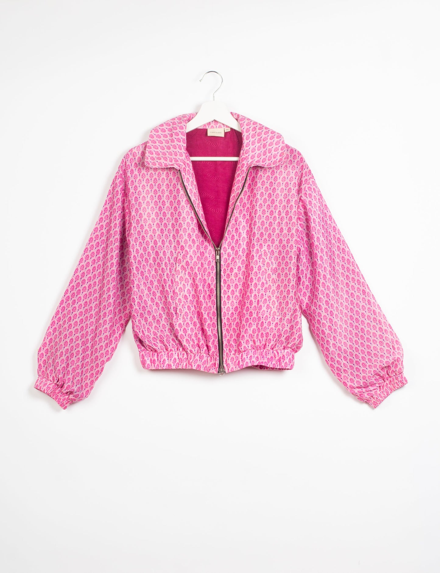 Stylish BOMBER JACKET, an upcycled clothing masterpiece with a cute cropped shape, elasticated details, and detachable metallic zipper. Contrast sari print lining adds a unique touch. Explore sustainable and eco-friendly fashion.