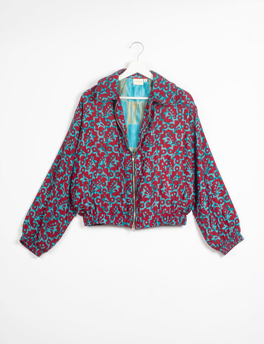 Stylish BOMBER JACKET, an upcycled clothing masterpiece with a cute cropped shape, elasticated details, and detachable metallic zipper. Contrast sari print lining adds a unique touch. Explore sustainable and eco-friendly fashion.