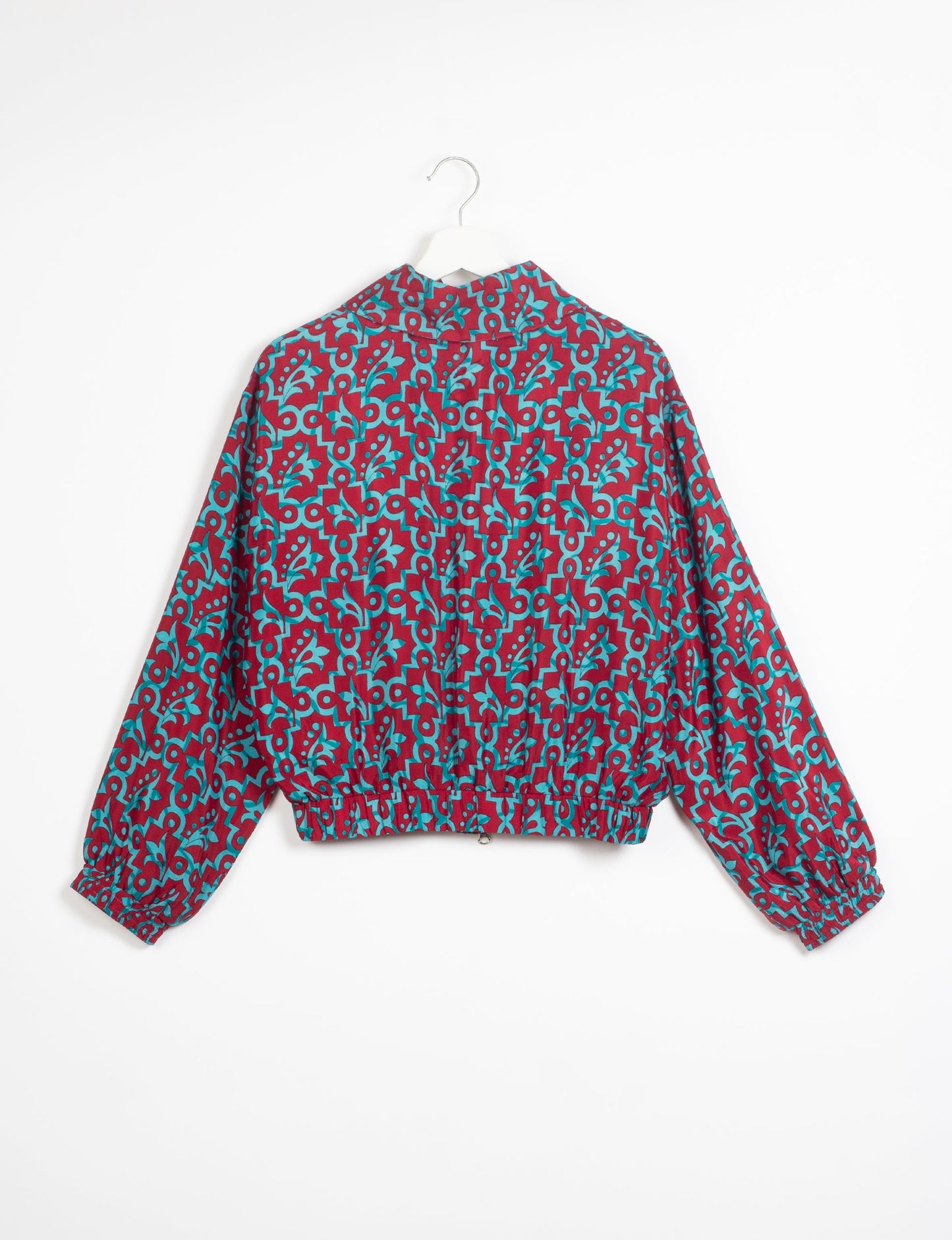 Stylish BOMBER JACKET, an upcycled clothing masterpiece with a cute cropped shape, elasticated details, and detachable metallic zipper. Contrast sari print lining adds a unique touch. Explore sustainable and eco-friendly fashion.