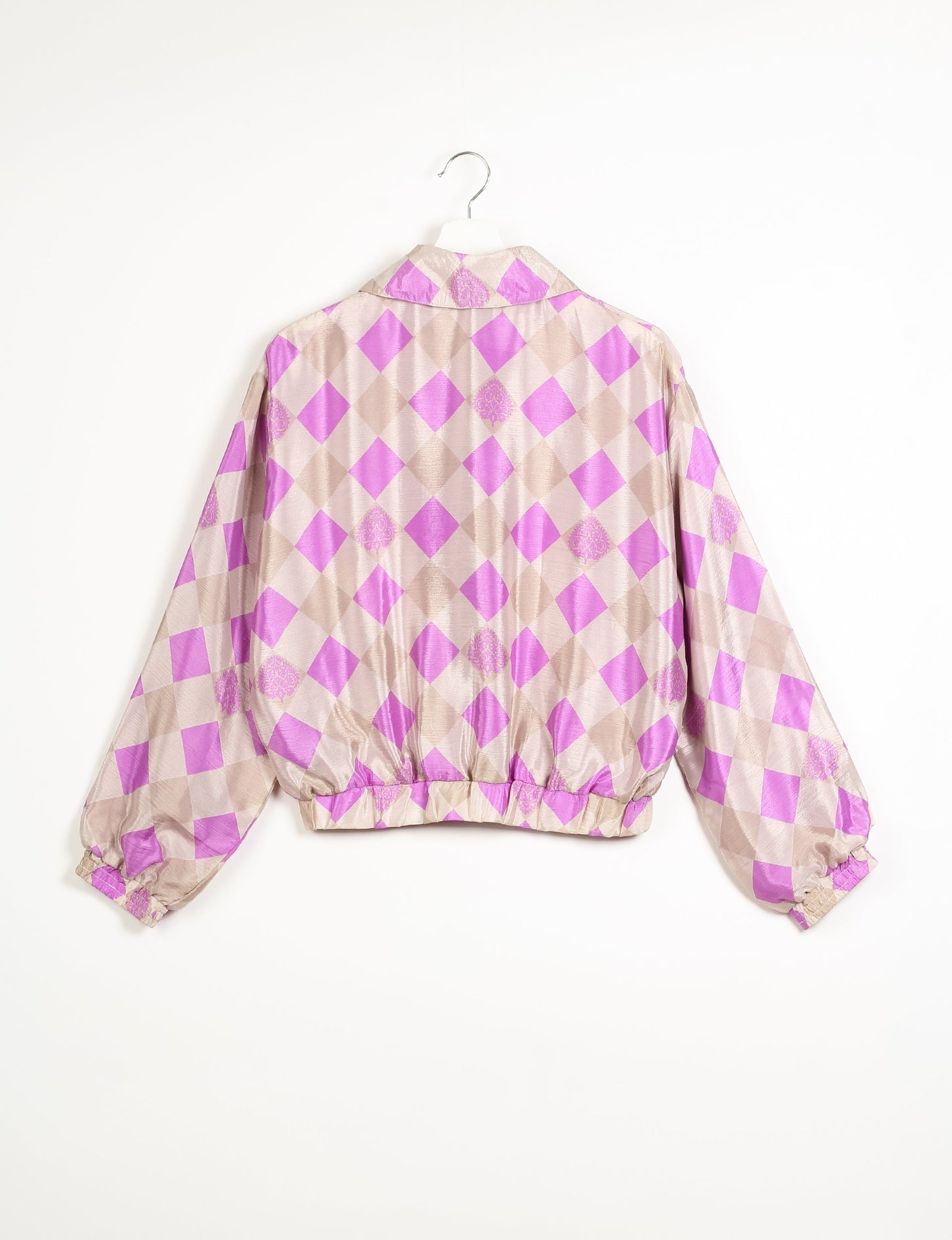 Stylish BOMBER JACKET, an upcycled clothing masterpiece with a cute cropped shape, elasticated details, and detachable metallic zipper. Contrast sari print lining adds a unique touch. Explore sustainable and eco-friendly fashion.