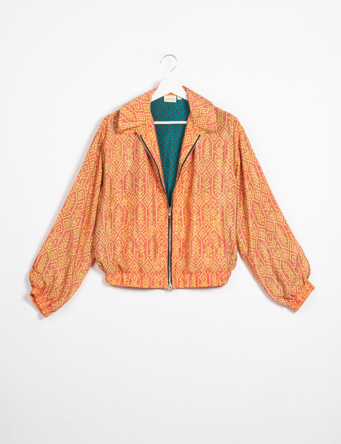 Stylish BOMBER JACKET, an upcycled clothing masterpiece with a cute cropped shape, elasticated details, and detachable metallic zipper. Contrast sari print lining adds a unique touch. Explore sustainable and eco-friendly fashion.