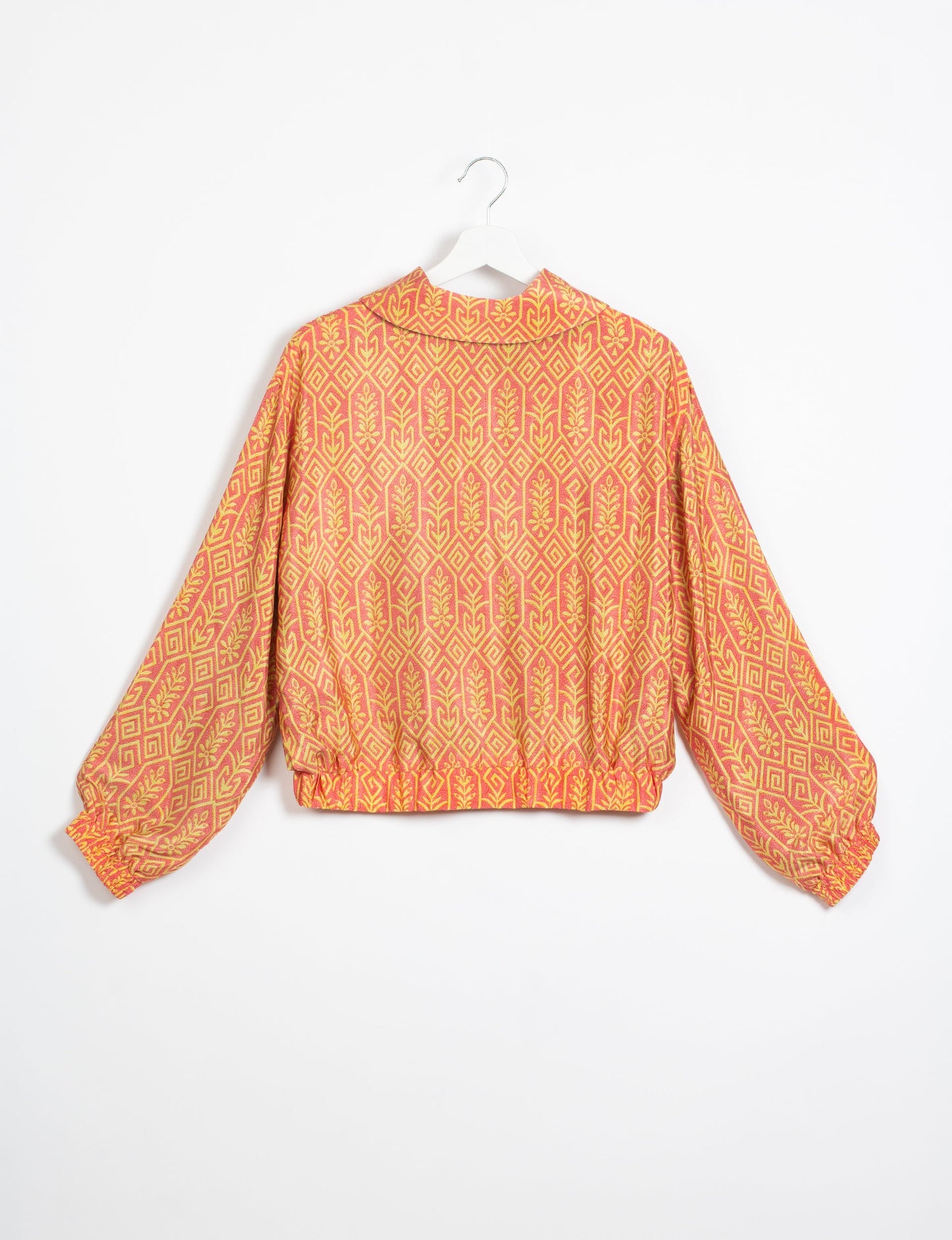 Stylish BOMBER JACKET, an upcycled clothing masterpiece with a cute cropped shape, elasticated details, and detachable metallic zipper. Contrast sari print lining adds a unique touch. Explore sustainable and eco-friendly fashion.