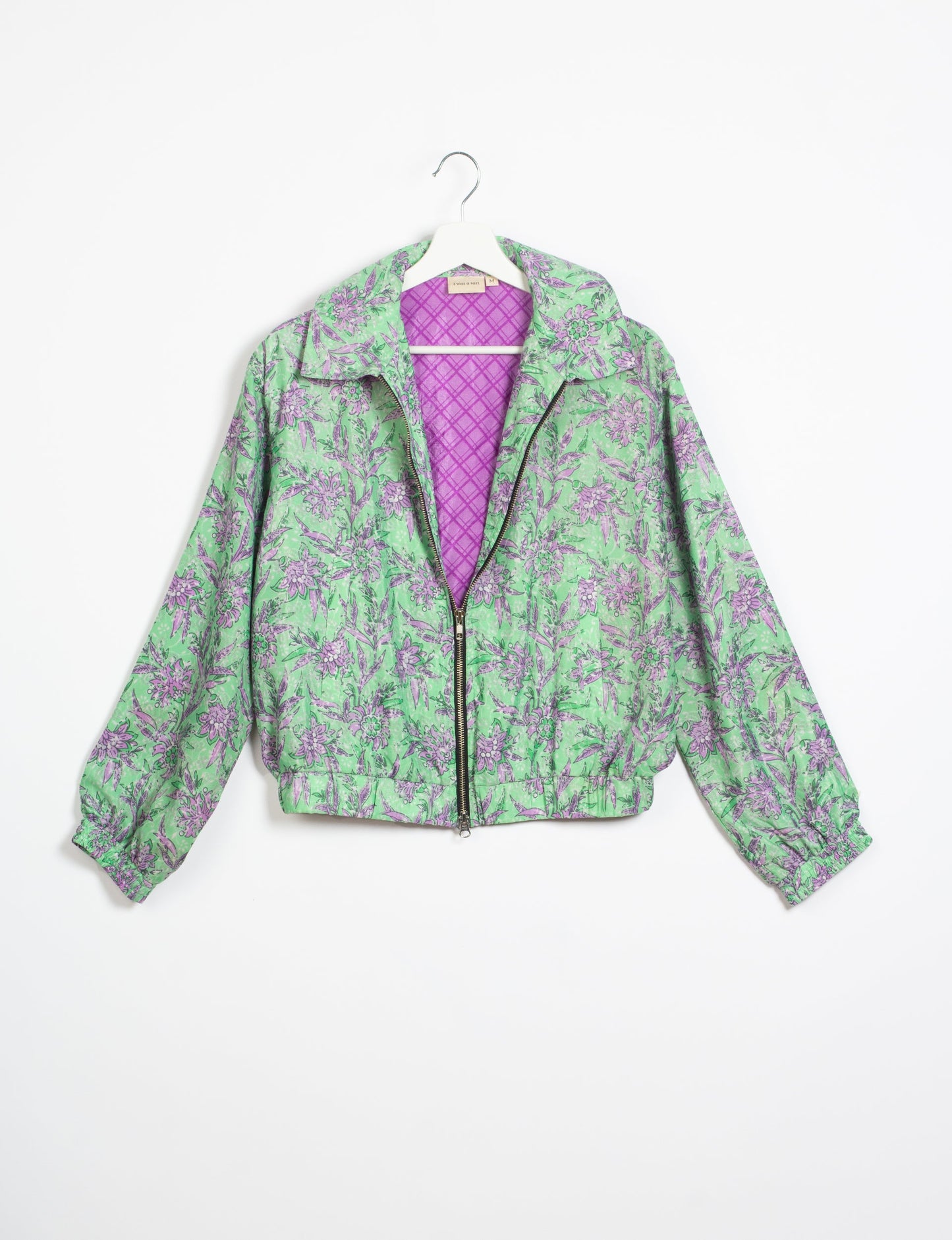 Stylish BOMBER JACKET, an upcycled clothing masterpiece with a cute cropped shape, elasticated details, and detachable metallic zipper. Contrast sari print lining adds a unique touch. Explore sustainable and eco-friendly fashion.