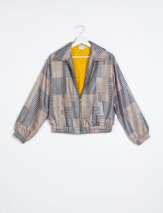 Stylish BOMBER JACKET, an upcycled clothing masterpiece with a cute cropped shape, elasticated details, and detachable metallic zipper. Contrast sari print lining adds a unique touch. Explore sustainable and eco-friendly fashion.