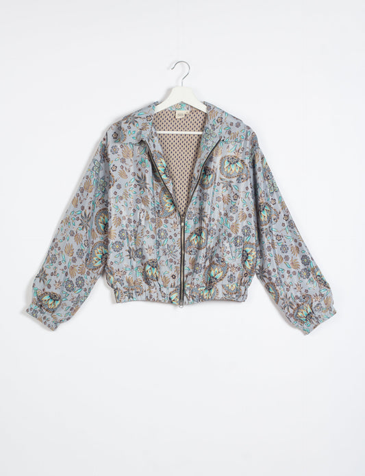 Stylish BOMBER JACKET, an upcycled clothing masterpiece with a cute cropped shape, elasticated details, and detachable metallic zipper. Contrast sari print lining adds a unique touch. Explore sustainable and eco-friendly fashion.