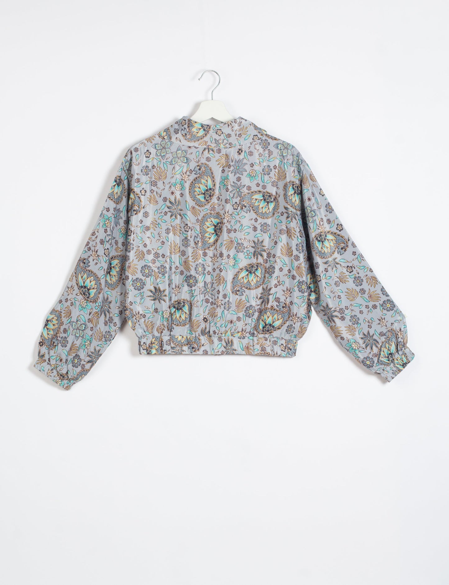 Stylish BOMBER JACKET, an upcycled clothing masterpiece with a cute cropped shape, elasticated details, and detachable metallic zipper. Contrast sari print lining adds a unique touch. Explore sustainable and eco-friendly fashion.