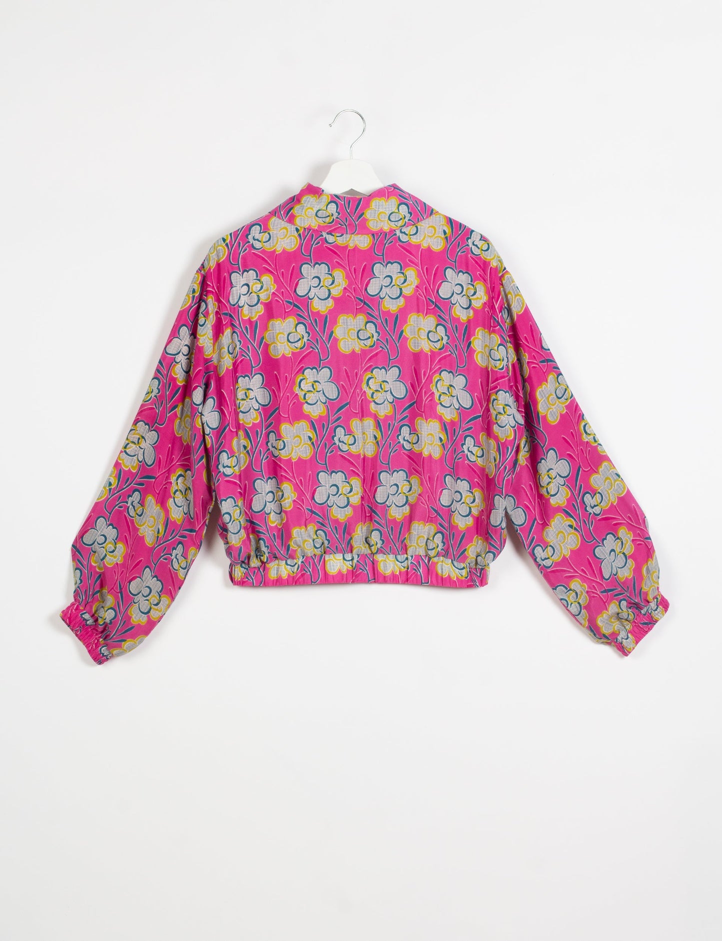 Stylish BOMBER JACKET, an upcycled clothing masterpiece with a cute cropped shape, elasticated details, and detachable metallic zipper. Contrast sari print lining adds a unique touch. Explore sustainable and eco-friendly fashion.