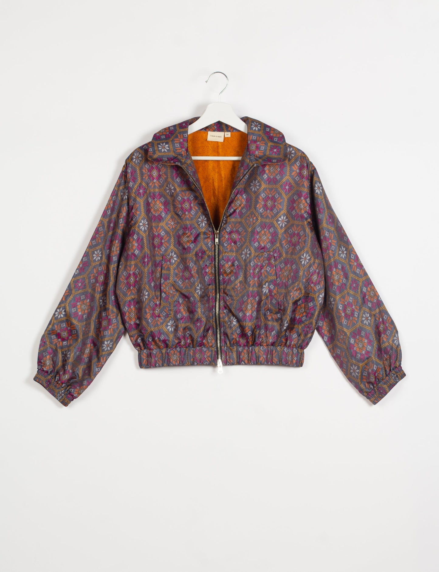 Stylish BOMBER JACKET, an upcycled clothing masterpiece with a cute cropped shape, elasticated details, and detachable metallic zipper. Contrast sari print lining adds a unique touch. Explore sustainable and eco-friendly fashion.