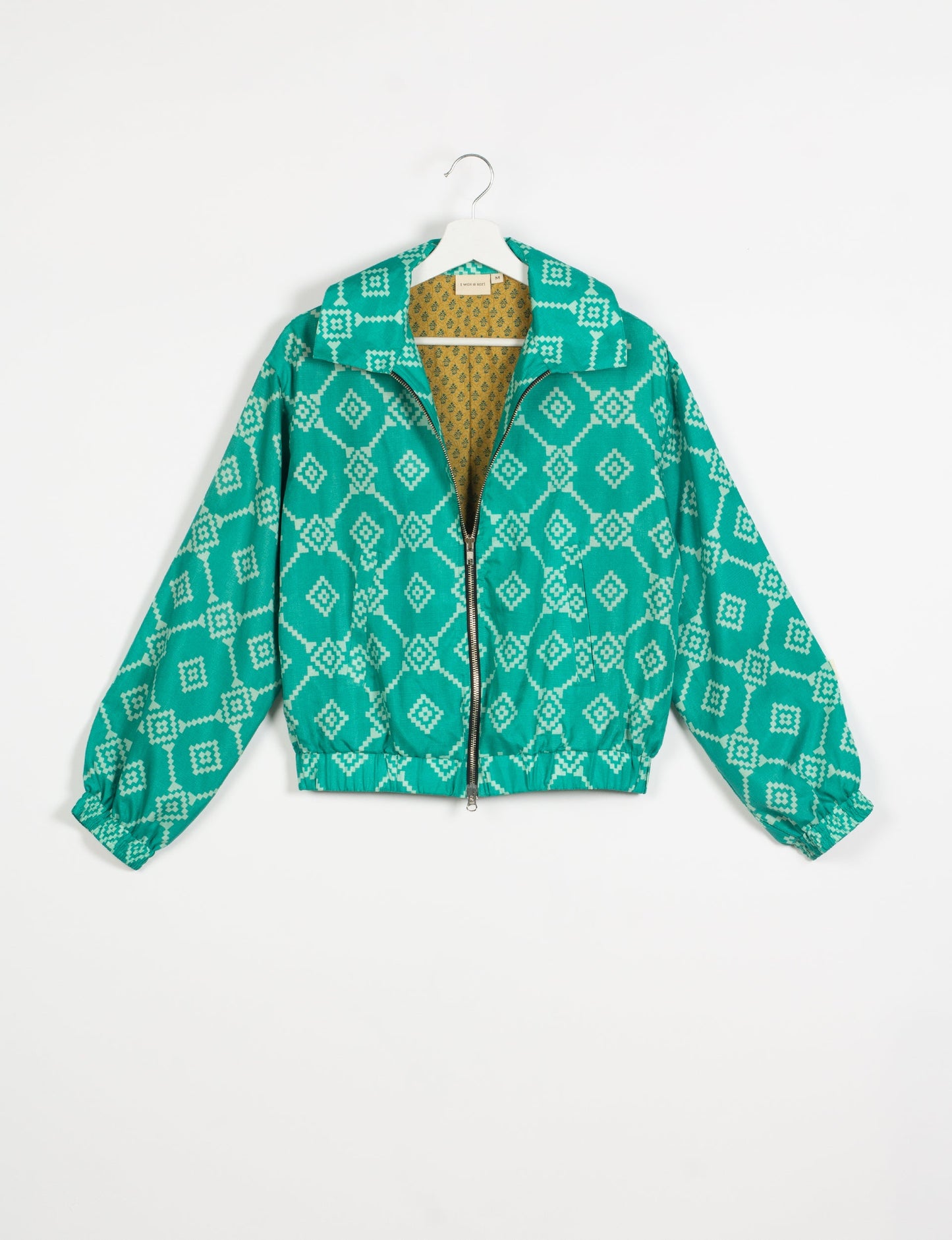 Stylish BOMBER JACKET, an upcycled clothing masterpiece with a cute cropped shape, elasticated details, and detachable metallic zipper. Contrast sari print lining adds a unique touch. Explore sustainable and eco-friendly fashion.