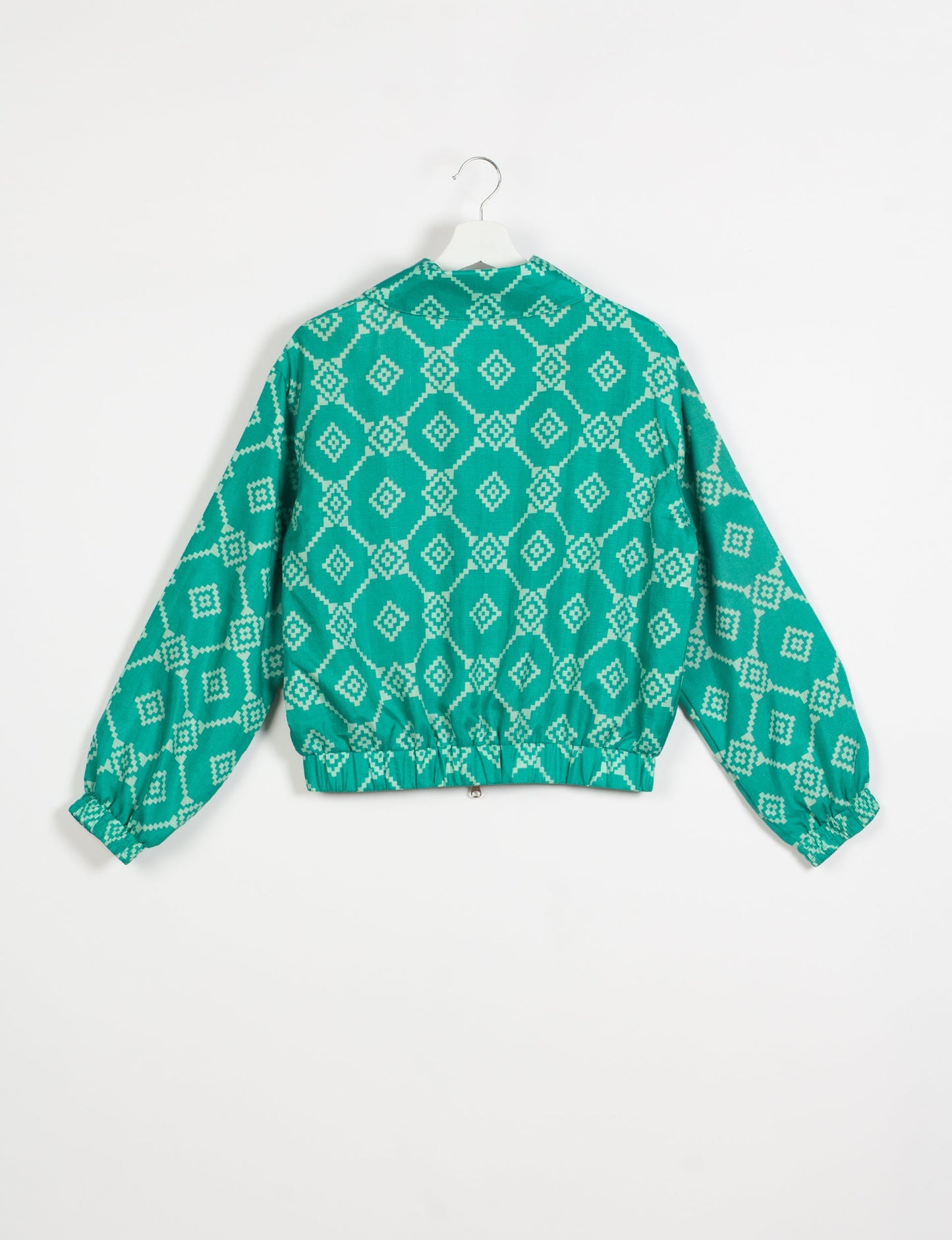 Stylish BOMBER JACKET, an upcycled clothing masterpiece with a cute cropped shape, elasticated details, and detachable metallic zipper. Contrast sari print lining adds a unique touch. Explore sustainable and eco-friendly fashion.