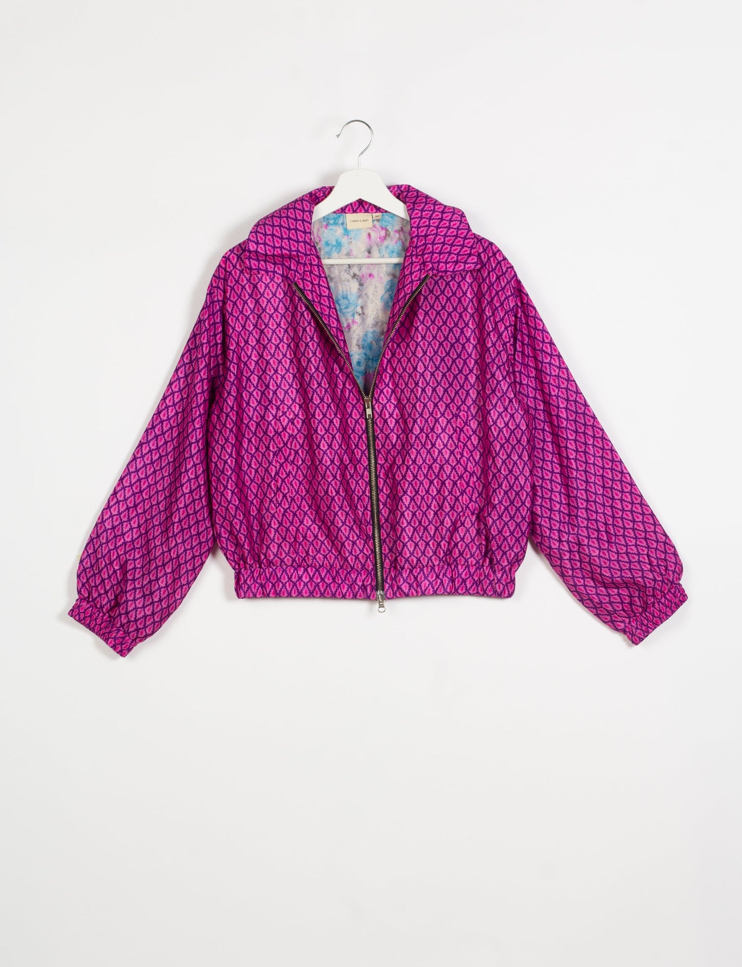 Stylish BOMBER JACKET, an upcycled clothing masterpiece with a cute cropped shape, elasticated details, and detachable metallic zipper. Contrast sari print lining adds a unique touch. Explore sustainable and eco-friendly fashion.