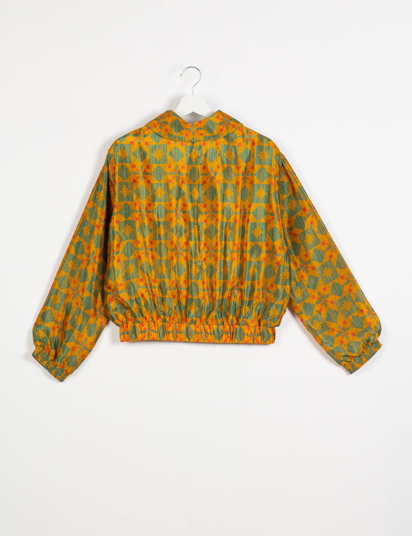 Stylish BOMBER JACKET, an upcycled clothing masterpiece with a cute cropped shape, elasticated details, and detachable metallic zipper. Contrast sari print lining adds a unique touch. Explore sustainable and eco-friendly fashion.