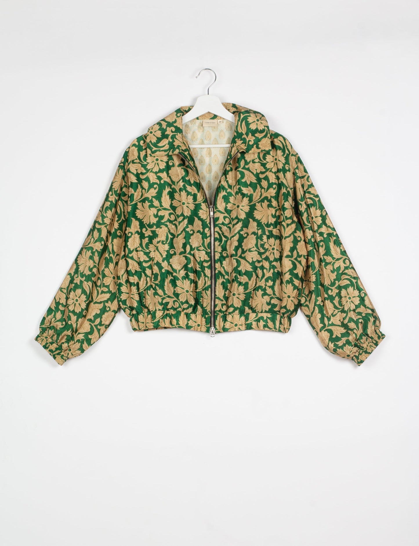 Stylish BOMBER JACKET, an upcycled clothing masterpiece with a cute cropped shape, elasticated details, and detachable metallic zipper. Contrast sari print lining adds a unique touch. Explore sustainable and eco-friendly fashion.