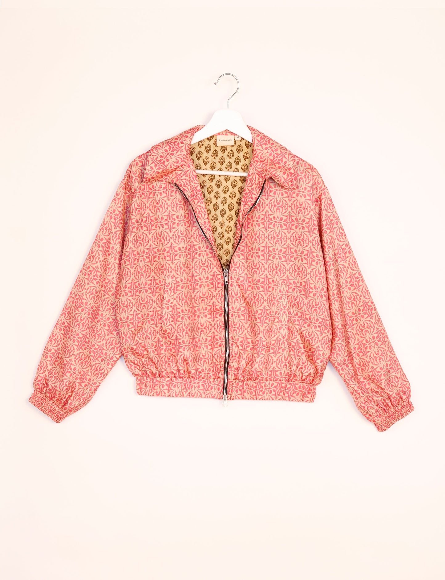 Stylish BOMBER JACKET, an upcycled clothing masterpiece with a cute cropped shape, elasticated details, and detachable metallic zipper. Contrast sari print lining adds a unique touch. Explore sustainable and eco-friendly fashion.