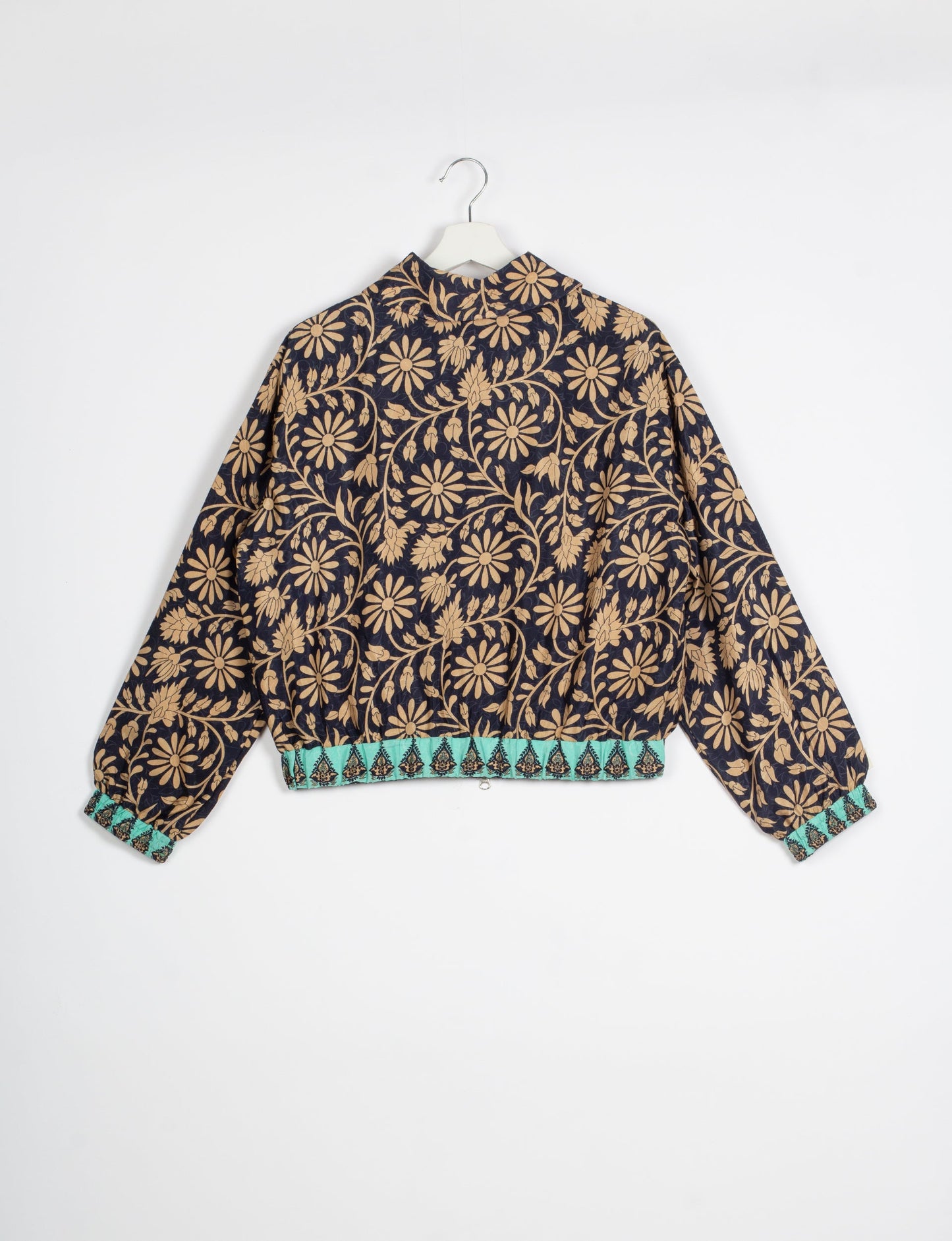 Stylish BOMBER JACKET, an upcycled clothing masterpiece with a cute cropped shape, elasticated details, and detachable metallic zipper. Contrast sari print lining adds a unique touch. Explore sustainable and eco-friendly fashion.