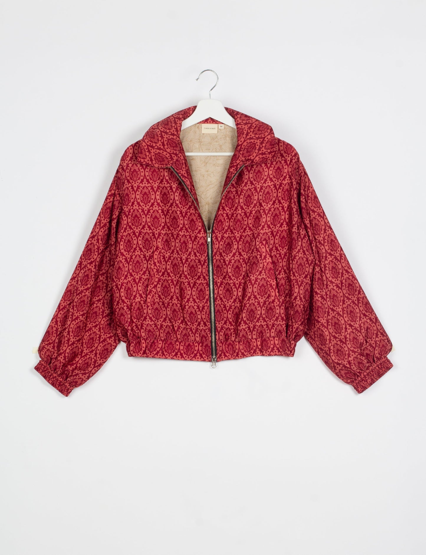 Stylish BOMBER JACKET, an upcycled clothing masterpiece with a cute cropped shape, elasticated details, and detachable metallic zipper. Contrast sari print lining adds a unique touch. Explore sustainable and eco-friendly fashion.