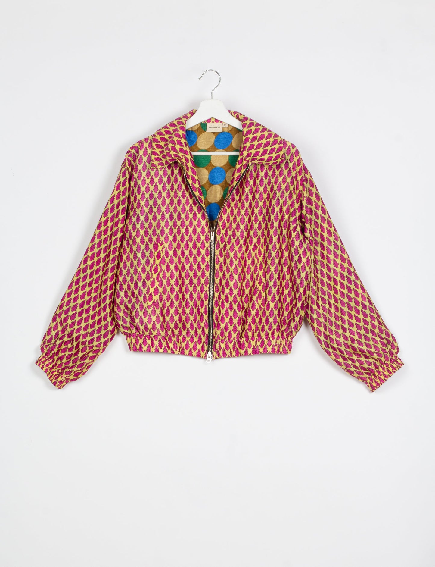 Stylish BOMBER JACKET, an upcycled clothing masterpiece with a cute cropped shape, elasticated details, and detachable metallic zipper. Contrast sari print lining adds a unique touch. Explore sustainable and eco-friendly fashion.