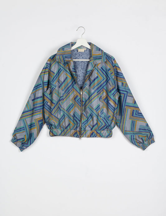 Stylish BOMBER JACKET, an upcycled clothing masterpiece with a cute cropped shape, elasticated details, and detachable metallic zipper. Contrast sari print lining adds a unique touch. Explore sustainable and eco-friendly fashion.